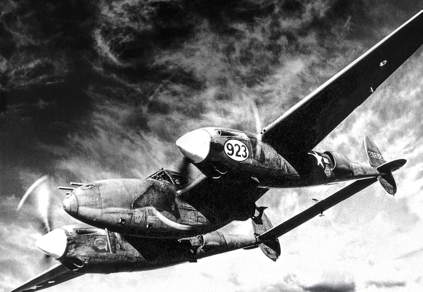 Black-and-white World War II illustration of a Lockheed P-38 Lightning fighter aircraft in flight, showing its distinctive twin-engine, twin-boom design. This aircraft was notable for its long range, making it one of the few Allied planes capable of executing deep missions in the Pacific Theater. The P-38’s central nacelle houses the cockpit and heavy armament, including four .50 caliber machine guns and a 20mm cannon. Used extensively by the United States Army Air Forces, the P-38 played a critical role in intercepting Japanese bombers and escorts during Operation Vengeance in 1943. The plane’s rugged construction and firepower gave it an advantage against Japanese Mitsubishi Zero fighters. It served in both European and Pacific operations but is most remembered for its contribution to Yamamoto’s shootdown mission.