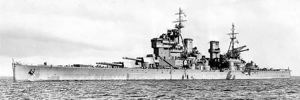 The image shows HMS Prince of Wales, a British King George V–class battleship, at sea not long after her launch in 1939. She displays a sleek hull, heavy armor, and large-caliber naval guns in multiple turrets. As one of the Royal Navy’s newest battleships, she was designed to meet the growing threats of World War II. Despite her modern firepower and radar systems, Prince of Wales was sunk on December 10, 1941, by Japanese land-based bombers and torpedo planes off the coast of Malaya. The attack came just days after Pearl Harbor and marked the first time in history that capital ships operating at sea had been sunk solely by aircraft. The photo captures her as a symbol of British naval strength that quickly proved obsolete against modern air power.