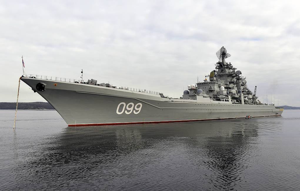 The photo shows the Russian Navy’s battlecruiser Pyotr Veliky sailing at sea, a massive vessel that is part of the Kirov-class of nuclear-powered warships. The ship has a long, sleek hull with multiple superstructures rising above the deck, bristling with radars, missile launchers, and defensive systems. It is one of the largest non-carrier surface combatants in the world, heavily armed with anti-ship missiles, air defense systems, and naval guns. Pyotr Veliky was designed at the end of the Cold War to project Soviet naval power across the globe. The warship’s imposing size reflects an era when superpowers invested in large, heavily armed surface fleets. However, its continued operation is challenged by aging systems and high maintenance costs. This image highlights both the power and limitations of oversized warships in modern naval warfare.
