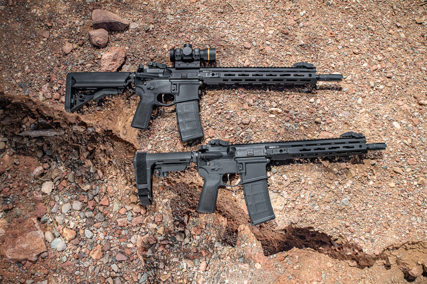 This image shows two Springfield Armory SAINT Victor 2 rifles displayed side by side for comparison. On the left is the 14-inch pinned and welded model, configured as a carbine chambered in 5.56 NATO. On the right is the shorter 11.5-inch pistol version, which uses an SB Tactical SBA3 brace instead of a stock. Both firearms share the same forged 7075 T6 receivers, free-float M-Lok handguards, and full-length Picatinny top rails. The 14-inch model features a B5 Systems Enhanced SOPMOD stock, while the pistol version is equipped with California-compliant alternatives depending on market. Each rifle includes the newly designed low-profile flip-up iron sights and four-prong flash hider. This side-by-side view emphasizes the range of options available in Springfield Armory’s expanded 2025 SAINT Victor lineup.