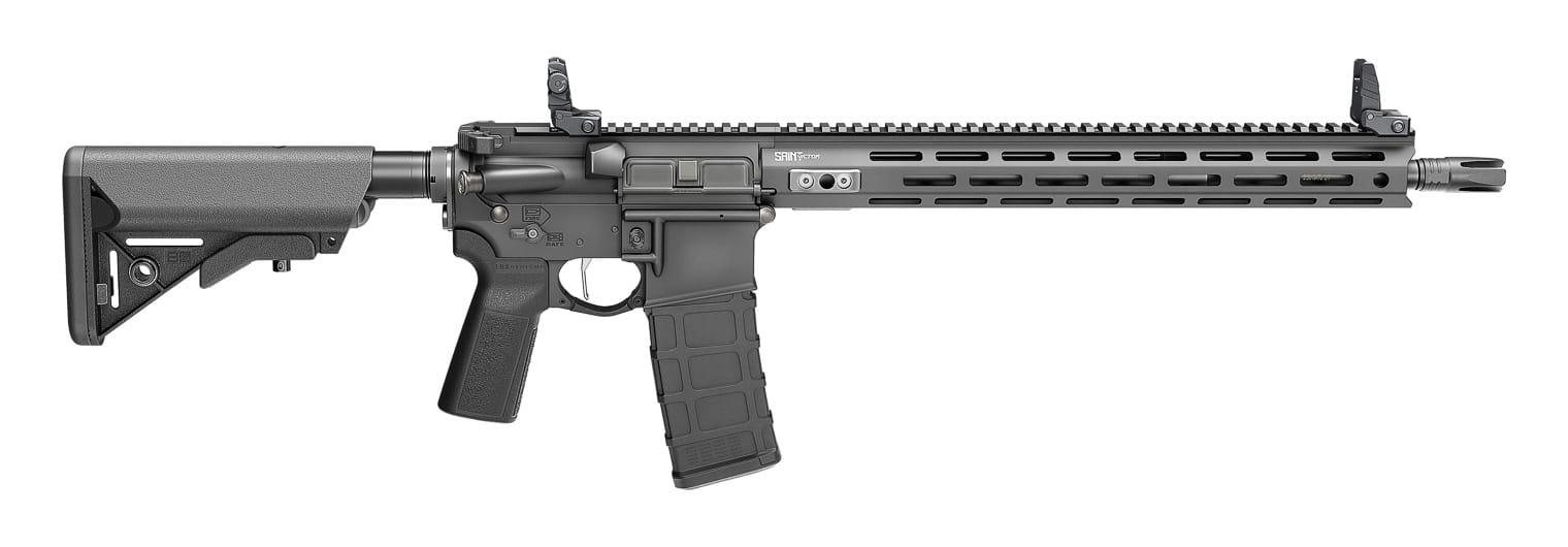 This image highlights the 2025 Springfield Armory SAINT Victor rifle update. The rifle shown retains the forged 7075 T6 aluminum receivers but features new low-profile engravings and a cleaner overall aesthetic. Visible on the rifle are the free-float aluminum handguard with M-Lok slots and the continuous Picatinny top rail for optics and accessories. The updated model includes ambidextrous controls, such as the 45-degree short-throw safety selector and Radian Raptor LT charging handle. A four-prong flash hider is installed at the muzzle, and the rifle comes standard with B5 Systems furniture, including the Enhanced SOPMOD stock and Type 23 P-Grip. The trigger is nickel boron-coated with a flat blade design, providing a durable and predictable pull. This updated configuration reflects Springfield Armory’s 2025 focus on refining details rather than making sweeping changes, giving shooters a polished and capable AR platform.