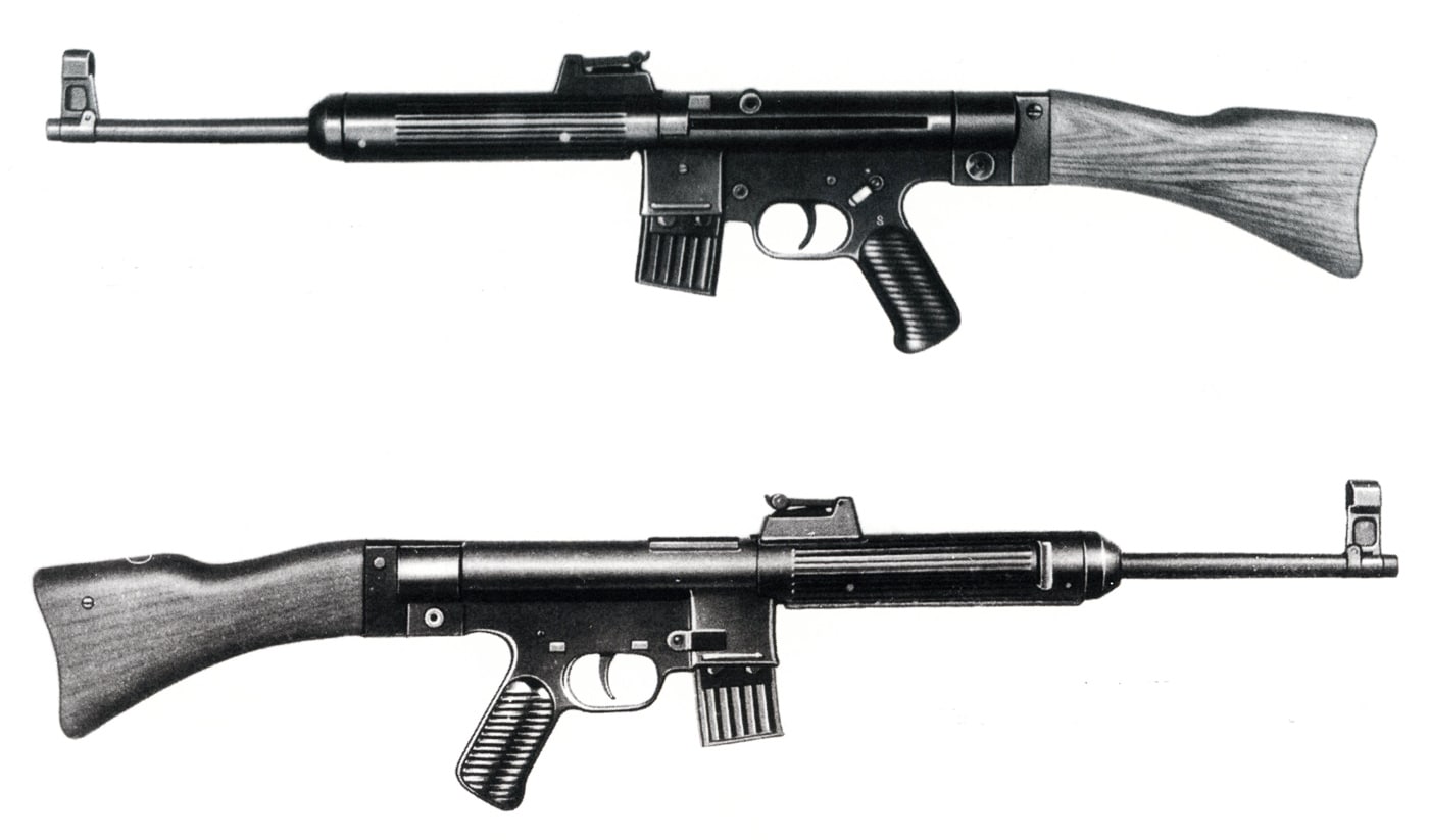The photo shows a German StG 45(M) assault rifle prototype that was captured by Soviet forces at the end of World War II. The rifle is displayed in complete form, with its stamped steel receiver, plain wooden stock, and short magazine. Its design incorporates the roller-delayed blowback system first developed by Mauser engineers. Soviet officers studied captured examples closely, comparing them with their own small arms projects. The captured rifle reflects Germany’s attempt to simplify the Sturmgewehr design during its final months of the war. Very few examples survived, making Soviet-held rifles important historical artifacts. The StG 45(M)’s innovative action influenced later weapons worldwide, though the Soviets ultimately pursued different designs with the AK-47.