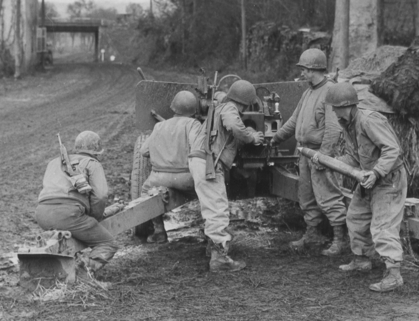 The photograph depicts US Army tank destroyer unit personnel during World War II equipped with M1 Carbines, illustrating what is a carbine developed for military support roles. The M1 Carbine was specifically designed as a lightweight weapon for vehicle crews, artillery personnel, officers, and support troops who needed more firepower than a pistol but found full-size rifles impractical. These soldiers represent the typical users of the M1 Carbine, which featured a shortened barrel and compact dimensions ideal for operations in and around military vehicles. The M1 Carbine fired the .30 Carbine cartridge, offering greater range and power than handguns while maintaining exceptional portability. Tank destroyer crews particularly benefited from the M1 Carbine's compact design, as they needed to quickly transition between operating their vehicles and engaging enemy infantry. The firearm weighed approximately five pounds, significantly lighter than the nine-pound M1 Garand rifle carried by standard infantry. Over six million M1 Carbines were produced during World War II, making it one of the most widely manufactured American military firearms in history. This image demonstrates the practical military application of carbine design principles during a pivotal period in firearms development.