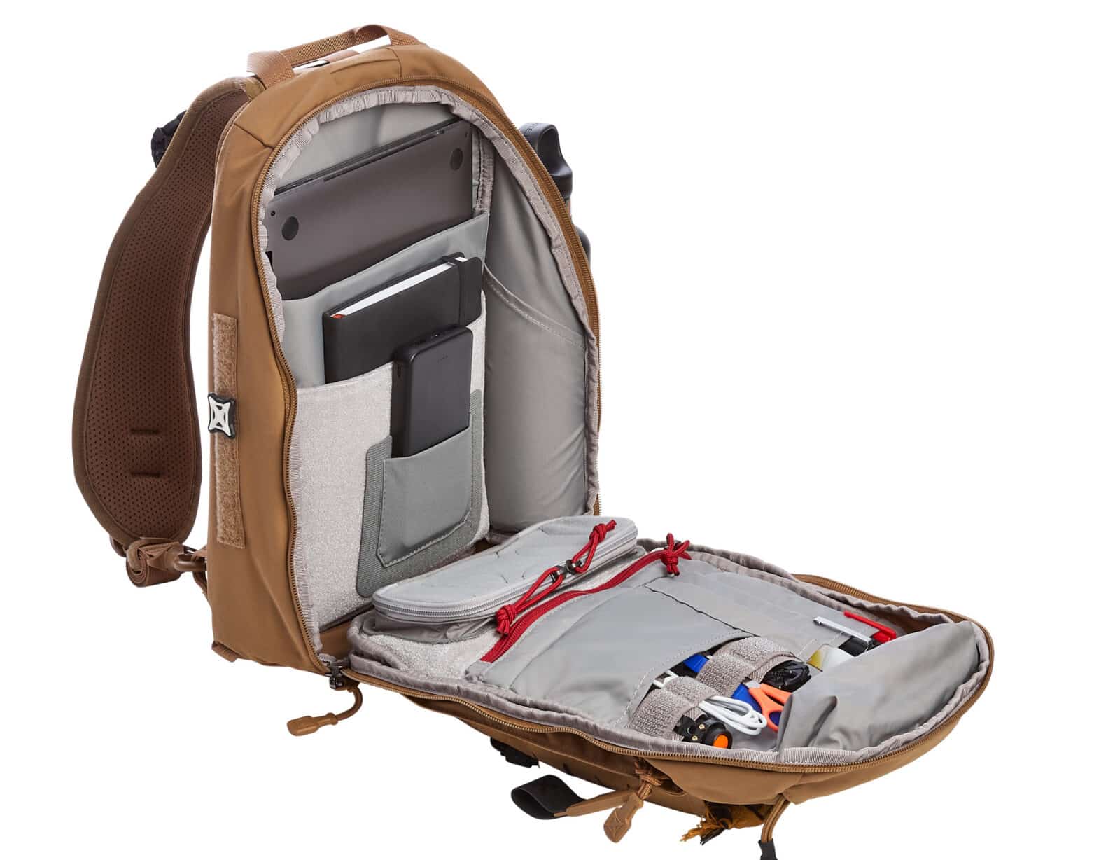 Photo of the inner front flap of the Vertx Siege 25L Tactical Backpack showing its organizational layout. The panel features elastic loops large enough to hold tools, flashlights, or even a subcompact pistol. A zippered mesh pocket with a loop face provides secure storage for smaller items. Several pen-sized sleeves are aligned for writing utensils or slim tools. The layout highlights modular design intended for everyday carry, tactical use, or travel organization. The durable nylon interior and reinforced stitching suggest long-term reliability. This section of the backpack emphasizes rapid access and efficient storage of essential gear.
