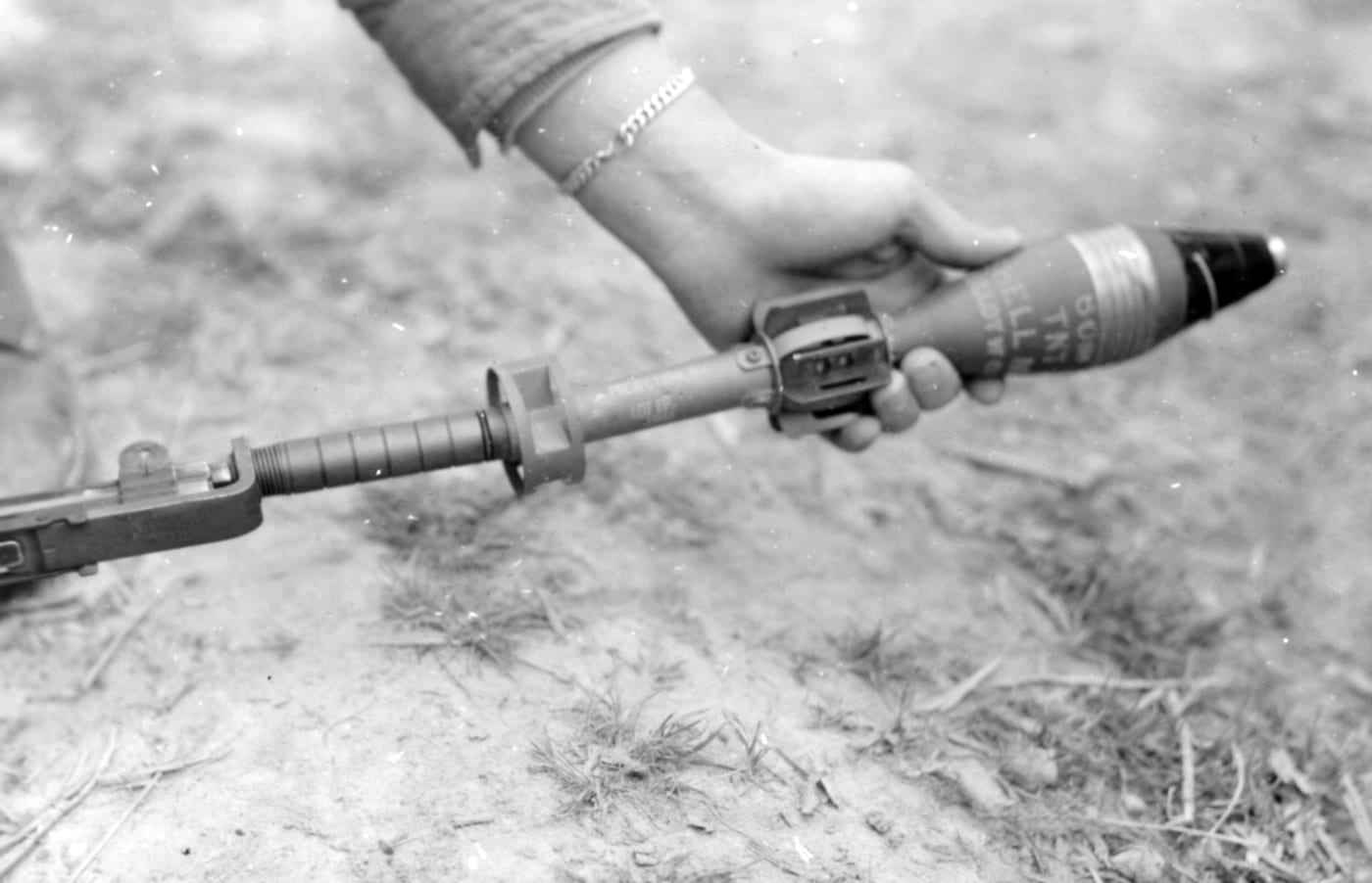 loading a 60mm mortar round on an M1 rifle