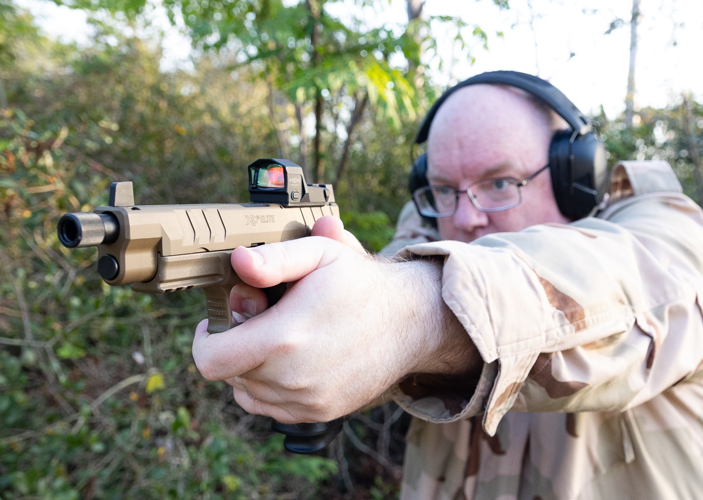 Shooter practicing with Springfield handgun at gun club range facility demonstrating membership benefits of unlimited shooting access. Gun clubs provide members with pistol ranges for regular practice without per-visit fees helping shooters develop marksmanship skills. Joining shooting clubs offers range access advantages including extended hours maintained facilities and cost savings over public range fees. Firearms club membership allows handgun owners to practice regularly at member ranges with pistol bays and shooting lanes. Shooting range club members benefit from convenient access to practice facilities for developing proficiency with pistols and improving marksmanship through consistent training sessions.