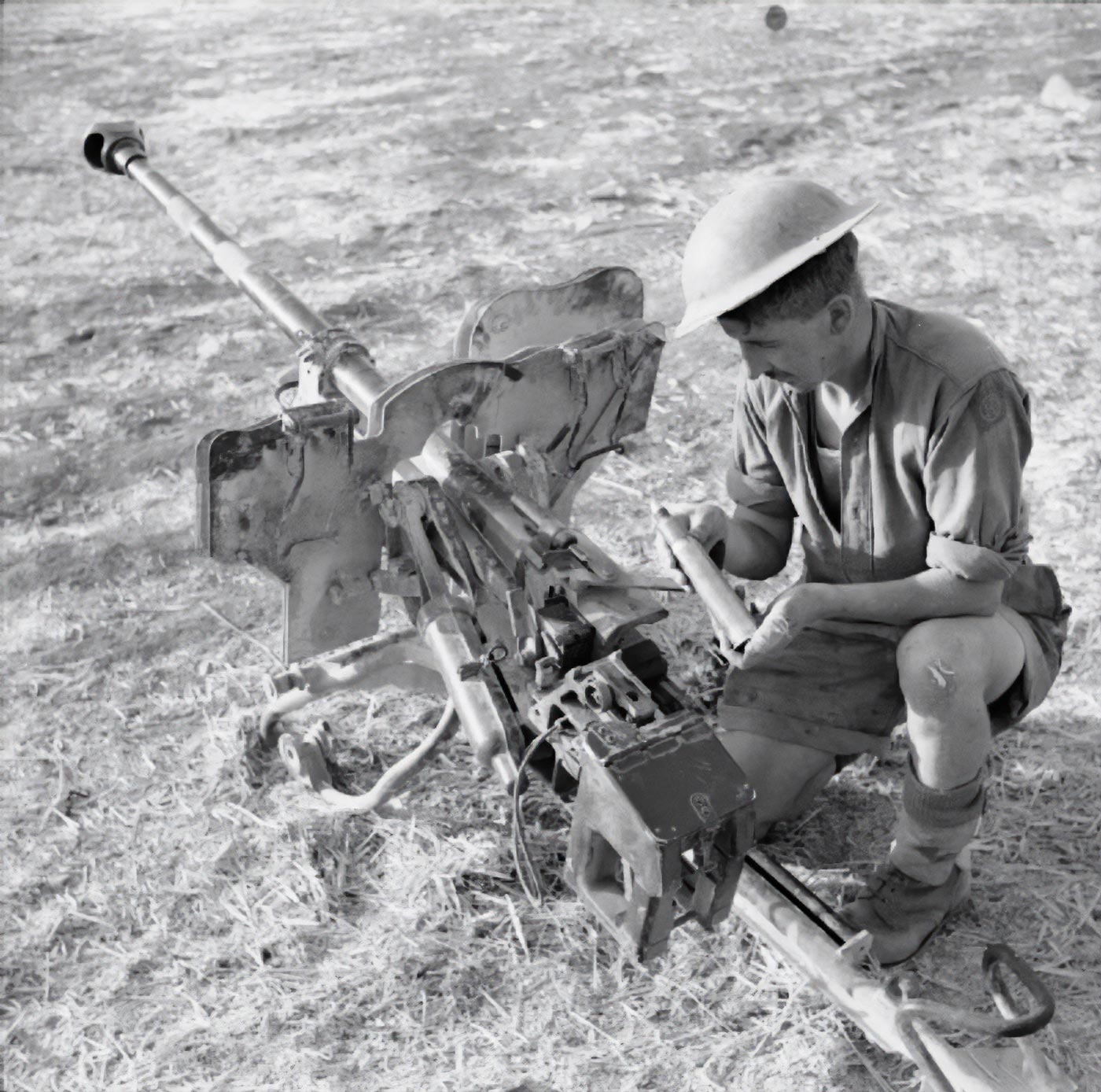 A German 2.8 cm sPzB 41 anti-tank gun is shown after being captured in Sicily during World War II. The weapon is positioned abandoned, no longer in German use. This squeeze-bore gun featured a barrel that tapered from 28 mm to 20 mm, dramatically increasing projectile velocity. It could penetrate light and some medium tanks at close to medium ranges. Despite its effectiveness, it relied on tungsten-cored ammunition, which was in short supply. The capture of this weapon illustrates how Allied forces encountered and studied German specialized equipment in the Mediterranean theater.
