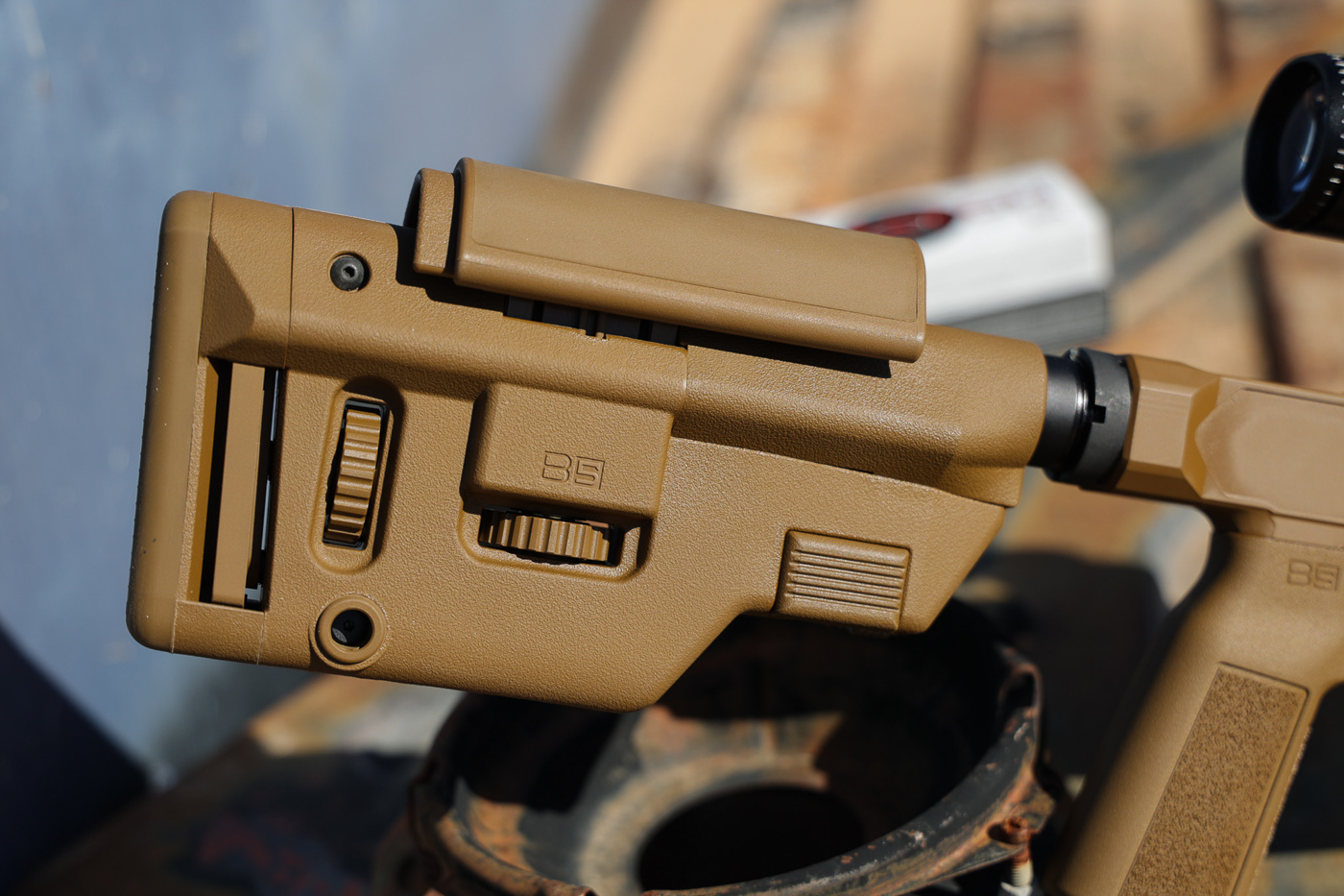 B5 Systems Precision Collapsible Stock mounted on Springfield Model 2020 Heatseeker chassis rifle showing adjustable comb and length of pull features. The precision stock attaches to standard AR-pattern buffer tube with solid lockup eliminating movement common in lesser stocks. Dial wheel visible on stock allows micro adjustments for comb height ensuring proper eye alignment with mounted scope. The collapsible design uses buffer tube position stops while precision adjustments fine-tune final fit. Stock construction provides rigid cheek weld surface critical for consistent accuracy with bolt action precision rifles. Coyote Brown Cerakote finish on chassis complements black stock color. This stock choice appears on multiple precision rifles due to proven performance and adjustment range. Compatible with AR-15 buffer tubes making replacement and customization straightforward for shooters.