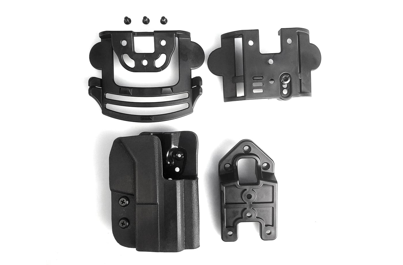 A detailed photo of the Comp-Tac International holster with both paddle attachment and belt mounting hardware displayed. The polymer paddle is curved to fit against the hip, while the belt mount includes adjustable slots for different belt widths. This modular holster system allows shooters to switch between paddle carry and traditional belt carry without needing a separate holster body. The hardware also enables adjustments for ride height and cant, making the setup adaptable for different shooting styles and body shapes. Comp-Tac holsters like this are popular among competition shooters and concealed carriers who want flexibility. SEO terms: Comp-Tac International holster, paddle holster hardware, belt mount holster, modular holster system. The image highlights the practical versatility of this holster platform.