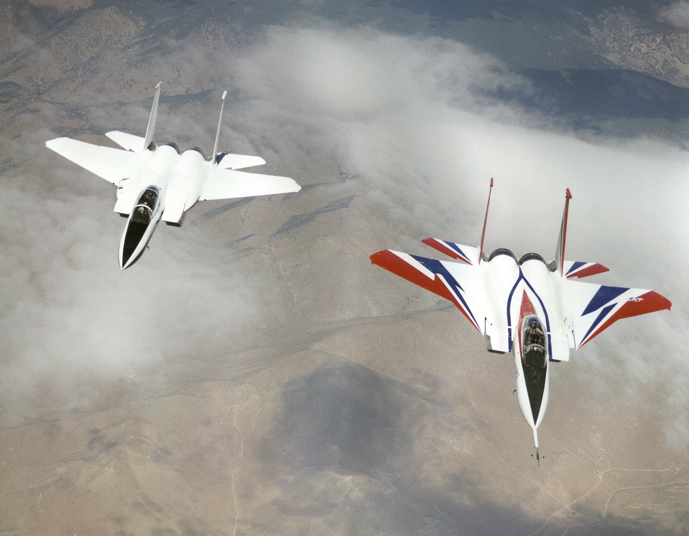 A NASA F-15B ACTIVE aircraft is shown in flight during an experimental test over California. The modified jet features distinctive forward canards and thrust-vectoring nozzles designed to test new flight control concepts. ACTIVE, short for Advanced Control Technology for Integrated Vehicles, was a joint NASA and U.S. Air Force program exploring how digital flight control systems could improve agility and safety. The aircraft, derived from the McDonnell Douglas F-15B, served as a test platform for advanced propulsion integration research. Its white and blue NASA livery distinguishes it from operational military Eagles. The image captures the aircraft in level flight under clear skies, symbolizing decades of innovation in aeronautical research.