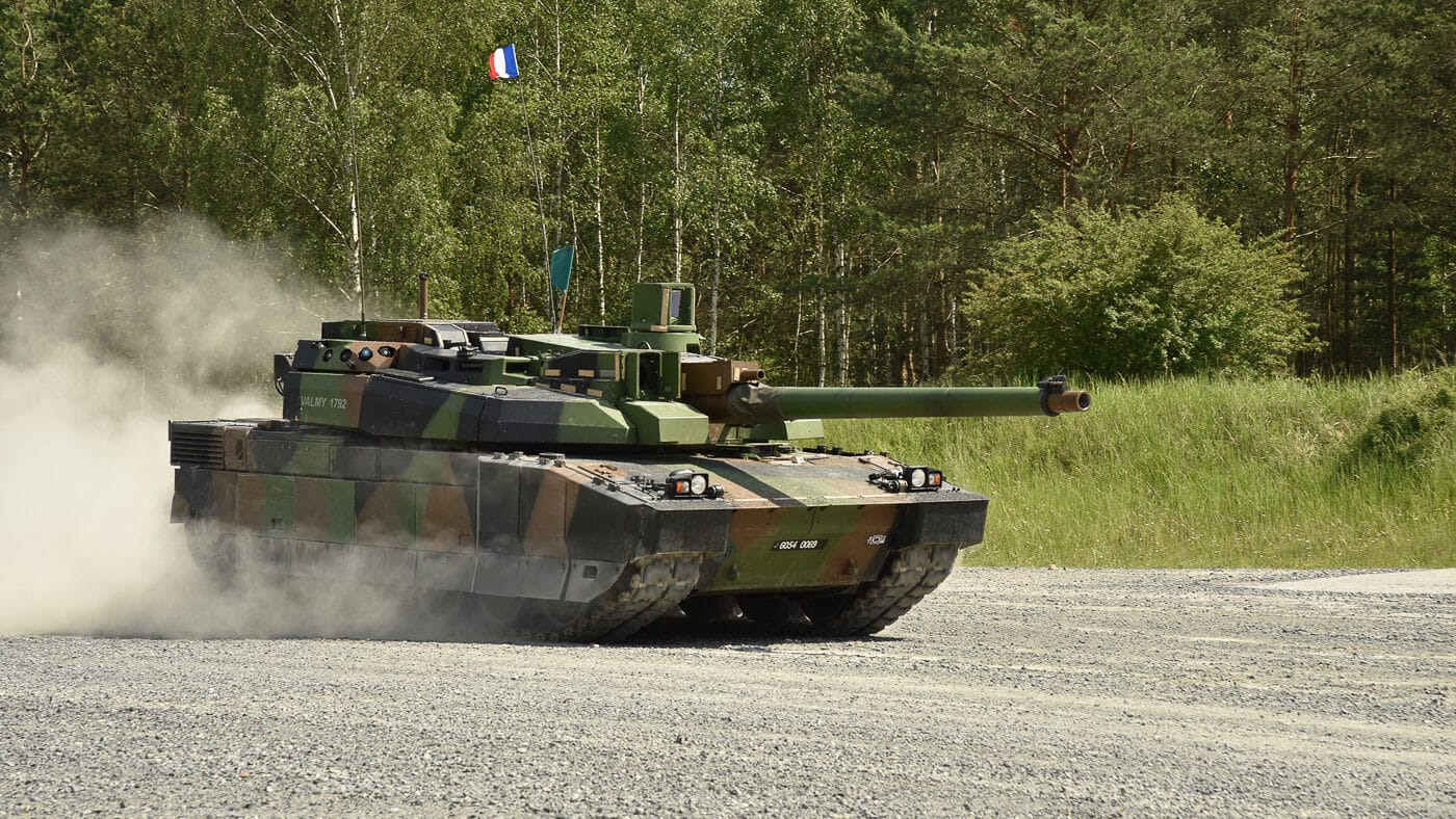 A French Leclerc tank belonging to the 1er Régiment de Chasseurs is shown during field training exercises. The tank is painted in standard camouflage and operates in open terrain, likely on a designated training ground. Its long 120mm gun and low turret design are clearly visible. The regiment, part of the French Army’s armored forces, has long been a primary operator of the Leclerc. Training emphasizes combined maneuvering, live-fire practice, and unit coordination. The photo underscores how France keeps its armored regiments combat-ready through regular field exercises.