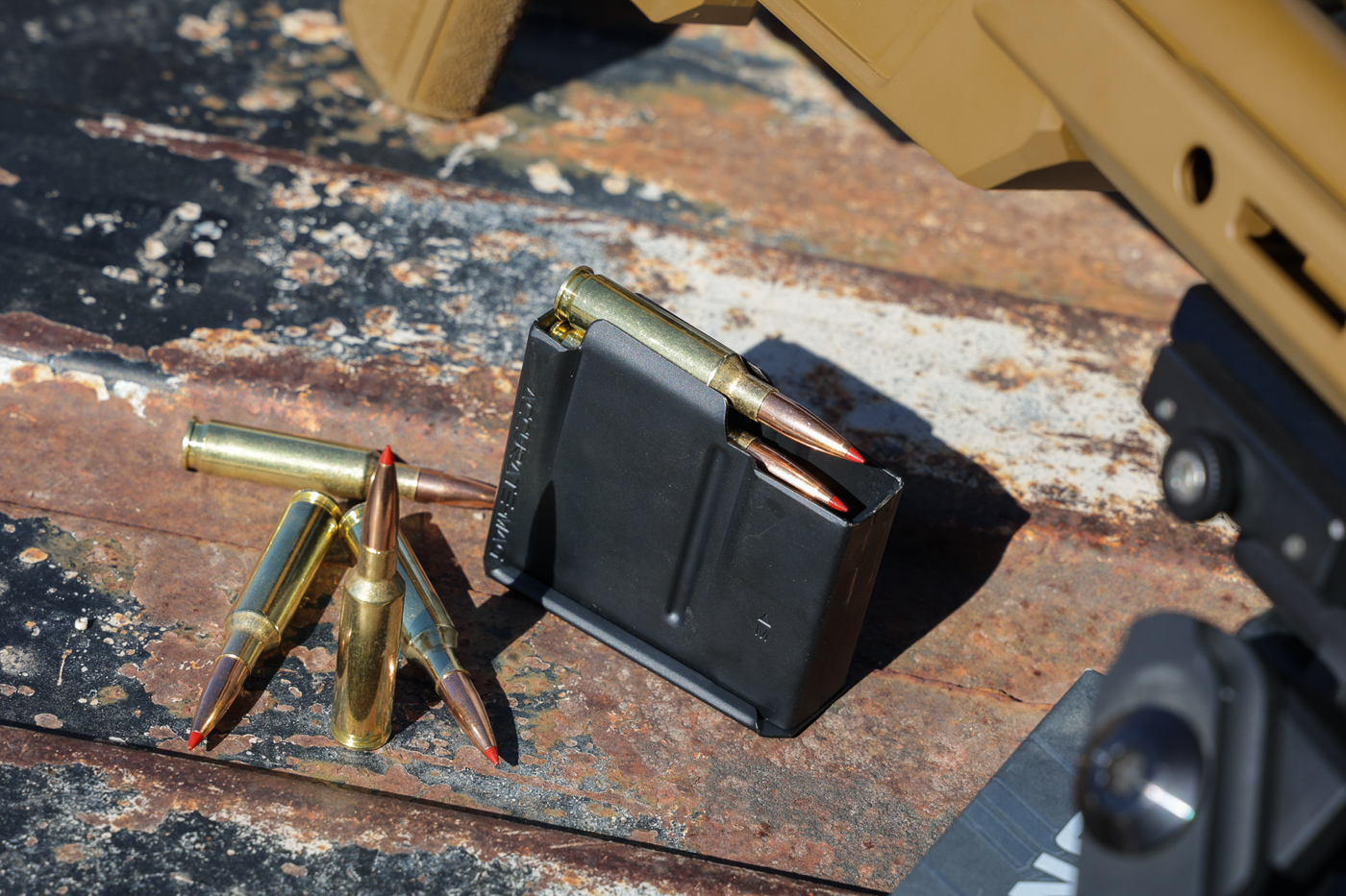 AICS-pattern metal magazine for Springfield Model 2020 Heatseeker loaded with Hornady factory ammunition in 6.5 Creedmoor caliber showing brass cartridge cases. The five-round magazine holds either 140-grain ELD Match or 143-grain ELD-X Precision Hunter loads used during accuracy testing. Magazine features steel construction with reliable feed geometry compatible with bolt action chassis rifles. Hornady ammunition visible with distinctive red polymer tips on ELD projectiles designed for ballistic consistency. Factory match and hunting loads from Hornady produced exceptional accuracy including sub-quarter MOA groups during range session. Magazine inserts and drops freely from chassis thanks to ambidextrous magazine release. Quality ammunition selection paramount for achieving accuracy potential of precision rifles with carbon fiber barrels. These loads proved well-suited to rifle's one-in-eight twist rate barrel delivering velocities optimized for 20-inch barrel length.