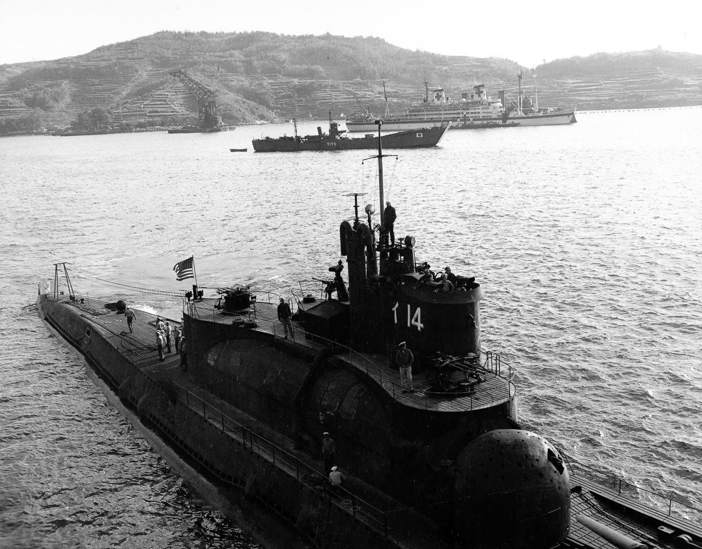 A historical photo of the Imperial Japanese Navy submarine I-14, one of the large I-class (Type A Mod. 2) submarines designed to carry reconnaissance aircraft in a sealed hangar. The image shows the vessel surfaced, highlighting its long hull, conning tower, and aircraft hangar section. The I-14 was part of Japan’s late-war program to develop submarine aircraft carriers capable of launching Aichi M6A Seiran floatplanes for surprise attacks. This submarine was assigned to the planned Panama Canal raid, known as Operation Arashi, which was ultimately canceled due to Japan’s surrender. The photograph illustrates the scale and ambition of Japan’s I-class designs, combining naval and air capabilities in a single platform.
