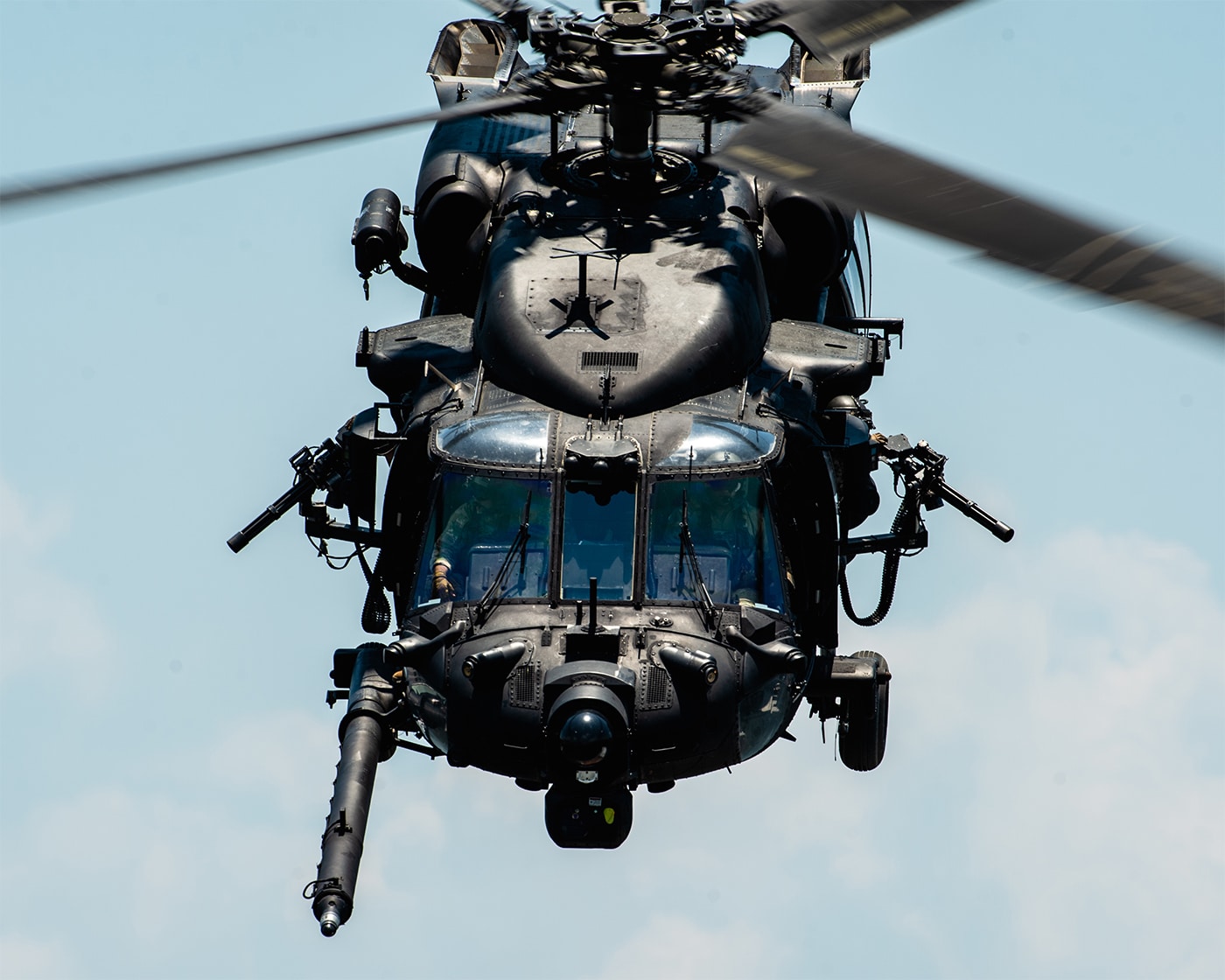A U.S. Army MH-60 Black Hawk helicopter, operated by the 160th Special Operations Aviation Regiment (Airborne), is seen conducting a flight demonstration during Special Operations Week in Tampa, Florida. The image shows the helicopter either in flight or hovering above a designated demonstration area, drawing attention from attendees. Soldiers may be visible inside or near the aircraft, displaying their tactical gear and readiness. The event setting includes elements typical of a public military demonstration, such as crowds, banners, or military vehicles in the background. This image emphasizes the MH-60’s importance to the Night Stalkers’ mission, especially in direct action and rapid deployment operations. The photo highlights the skill of the 160th SOAR (A) pilots and the advanced modifications on the helicopter. It represents the regiment’s ongoing commitment to operational excellence and innovation in Army aviation.