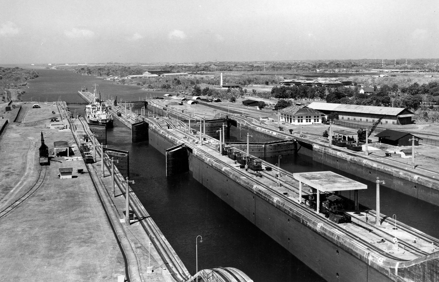 A historical aerial photo of the Gatun Locks in the Panama Canal, the proposed target of Japan’s planned submarine-launched air attack in 1945. The image shows the massive lock system connecting the Atlantic entrance of the canal, with chambers, gates, and surrounding waterways visible. Japanese military planners intended to strike this location using Aichi M6A Seiran bombers launched from I-400 and I-401 submarine aircraft carriers. The attack, part of the planned Operation Arashi, aimed to cripple Allied shipping by disabling the canal. The photograph highlights the engineering complexity of the locks and their strategic importance during World War II.