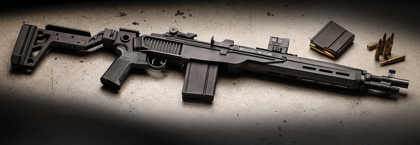 Springfield Armory M1A SOCOM rifle installed in a Delta 14 Chassis Gen 2 system showing the dramatic transformation from traditional wood furniture to modern polymer construction. The lightweight glass-filled nylon chassis weighs only 0.75 pounds while providing exceptional strength and heat resistance during rapid fire. Visible M-Lok slots along the forend allow for accessory mounting including lights, lasers, and vertical grips. The flared magwell design facilitates faster magazine changes under stress. The chassis features a steel front ferrule and universal steel T-nut mount for maximum durability despite the reduced weight. The Mossberg 500 pattern mount at the rear accepts a wide variety of buttstock options. This configuration maintains the M1A's proven 7.62 NATO chambering and gas-operated action while dramatically reducing overall package weight and size.