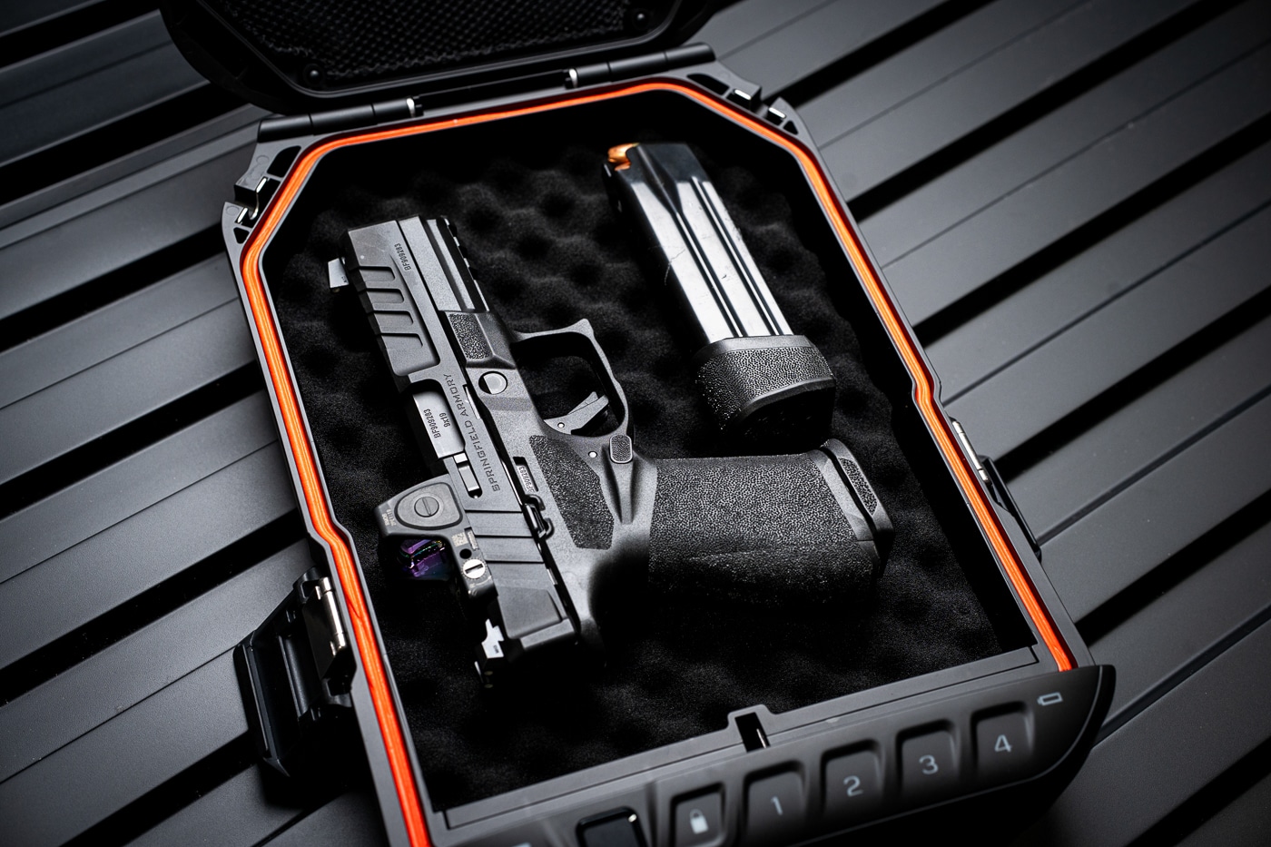 Interior view of a Vaultek Lifepod 20 Biometric portable safe containing a Springfield Armory Echelon 4.0F pistol and a spare magazine. The firearm rests securely in the foam-padded compartment, with the magazine placed alongside it. The interior tray and foam lining help prevent movement during travel and add protection against scratches or impact. This image demonstrates the Lifepod’s capacity to store a full-size handgun up to 9.25 inches with additional accessories. The LED light inside the case highlights the organized layout, showing how firearms and valuables can be accessed quickly. This ALT text describes the handgun, magazine, and safe interior for visually impaired users while optimizing for terms like firearm storage, handgun case, and travel gun safe.