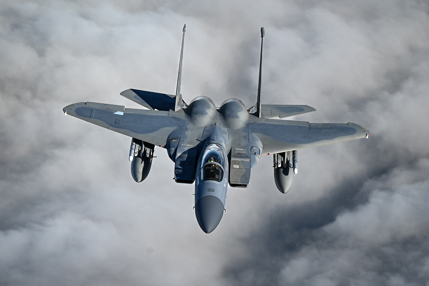 A U.S. Air Force F-15C Eagle is photographed in flight over the Atlantic waters off Natal, Brazil, during CRUZEX 2024 on November 4, 2024. The fighter flies as part of a larger formation, displaying its twin vertical tails, swept wings, and gray camouflage. This deployment marked one of the first times U.S. F-15s participated in the Brazilian-led multilateral exercise in South America. CRUZEX aims to enhance interoperability, readiness, and partnership among Americas’ air forces. The shot captures the jet in clear daylight, under a partly cloudy sky. The image reflects both power projection and cooperative defense training in a multinational context.
