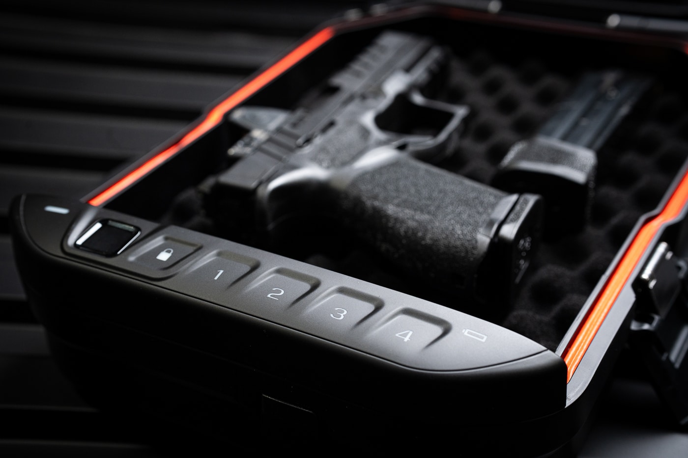 The Vaultek Lifepod 20 Biometric safe is shown in an overview image highlighting its exterior design. The case has a tough polymer shell with a smooth matte finish and low-profile latches for security. On the top, the biometric fingerprint reader and digital keypad are visible, showcasing the primary access methods. The size is compact but functional, intended for secure storage of handguns, electronics, jewelry, or travel essentials. Its clean design makes it appear less like a tactical item and more like modern tech gear. This photo conveys both durability and everyday usability for people looking for portable security.
