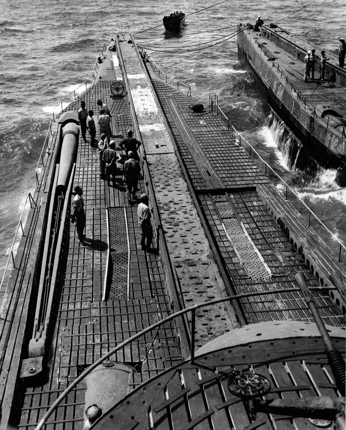 A detailed photograph of the I-14 submarine’s aircraft-launching catapult, positioned forward of the watertight hangar on the vessel’s deck. The image shows the long, metal catapult track used to launch floatplanes from the submarine’s surface. Beneath the launch rail were four high-pressure air flasks that powered the catapult piston, propelling aircraft like the Aichi M6A Seiran or smaller reconnaissance planes into flight. This system allowed Japan’s I-class submarines to deploy aircraft rapidly while surfaced, combining stealth and air mobility. The photo demonstrates the innovative yet complex engineering behind Japan’s underwater aircraft carrier design during World War II.