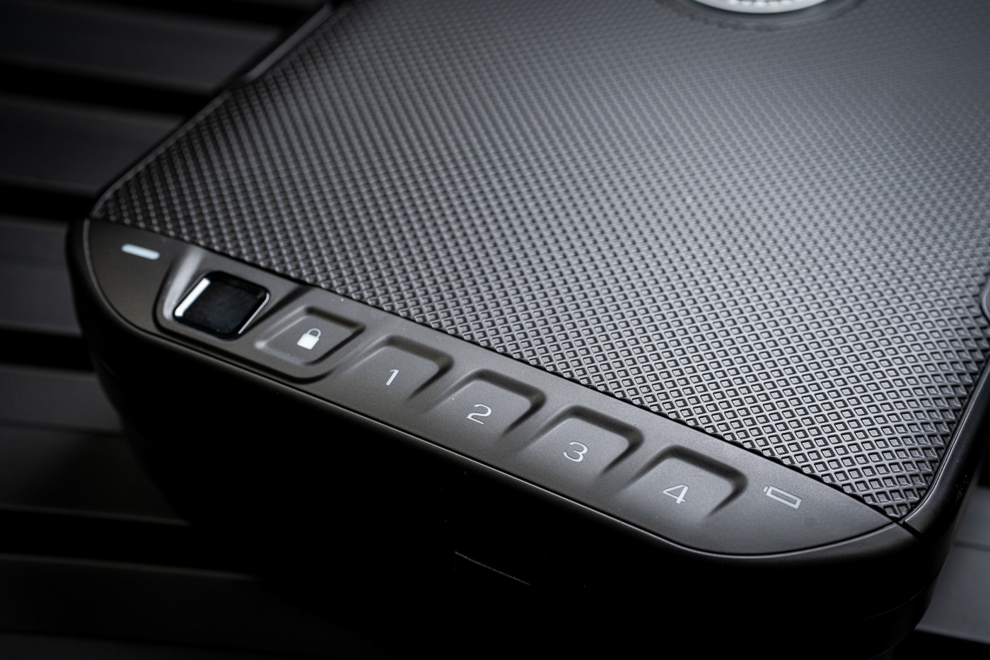 Close-up view of the Vaultek Lifepod 20 Biometric keypad locking mechanism. The backlit keypad is visible on the top of the case, positioned next to the fingerprint scanner for quick access. The buttons are clearly marked and designed to be used in both daylight and low-light conditions. This keypad accepts up to four master codes, giving users multiple ways to unlock the safe without relying solely on the biometric scanner. The compact design ensures the lock remains easy to use while keeping the case streamlined and travel-friendly. The keypad is an important backup system for travelers, firearm owners, and anyone storing valuables on the go.
