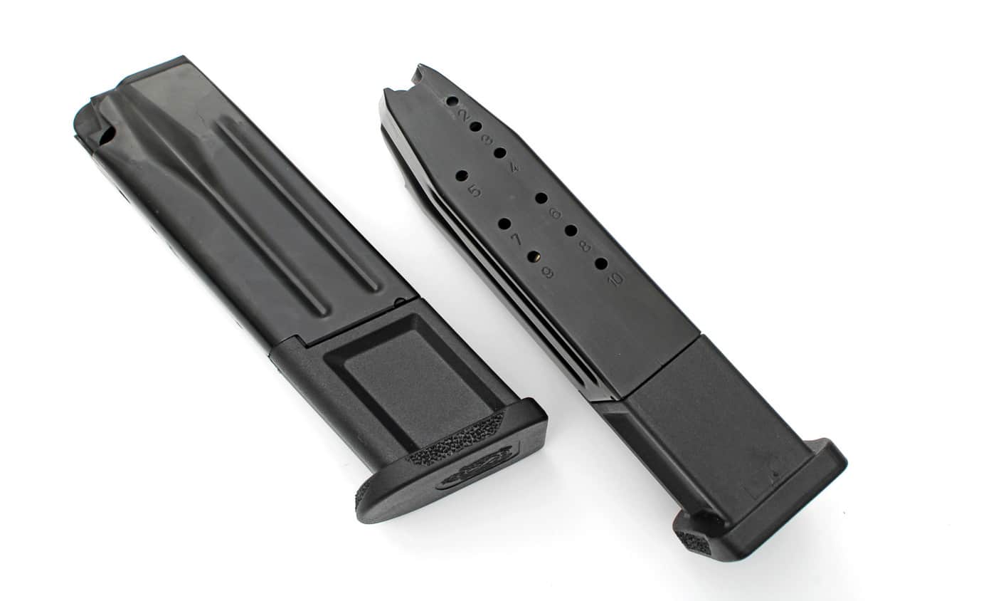 The image shows two California-compliant magazines for the Springfield Armory Echelon pistol, laid side by side on a neutral surface. Each magazine is constructed from steel with a black finish and has clear witness holes or capacity markings on the body for round count visibility. The baseplates are reinforced and appear compatible with both the compact and full-size California-compliant Echelon models. Both magazines are unloaded and displayed with the follower and feed lips in clear view. This photo serves to illustrate state-compliant magazine options, helping readers understand differences in design, capacity, and construction.