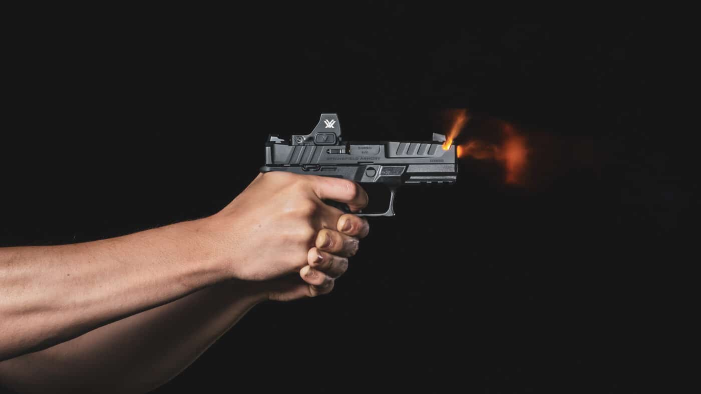 Detailed photograph illustrating proper grip technique on a Springfield Armory Echelon 9mm pistol with emphasis on hand positioning and grip frame contact. The dominant hand thumb middle ring and little finger tightly encircle the grip frame while the support hand provides complementary pressure from the opposite side. This firm two-hand grip is the shooter's connection to the pistol and when optimized allows the shooter to perform to full potential. The distal pad of the index finger is properly positioned on the trigger face demonstrating correct hand fit for this particular shooter. Interchangeable backstraps on the Echelon ensure the backstrap can be properly centered in the thumb crotch between thumb and index finger regardless of hand size. Pay attention to your grip when shooting because a less-than-optimal grip will compromise trigger control and cause sights to move off the point of aim as soon as rearward pressure is applied to the trigger.