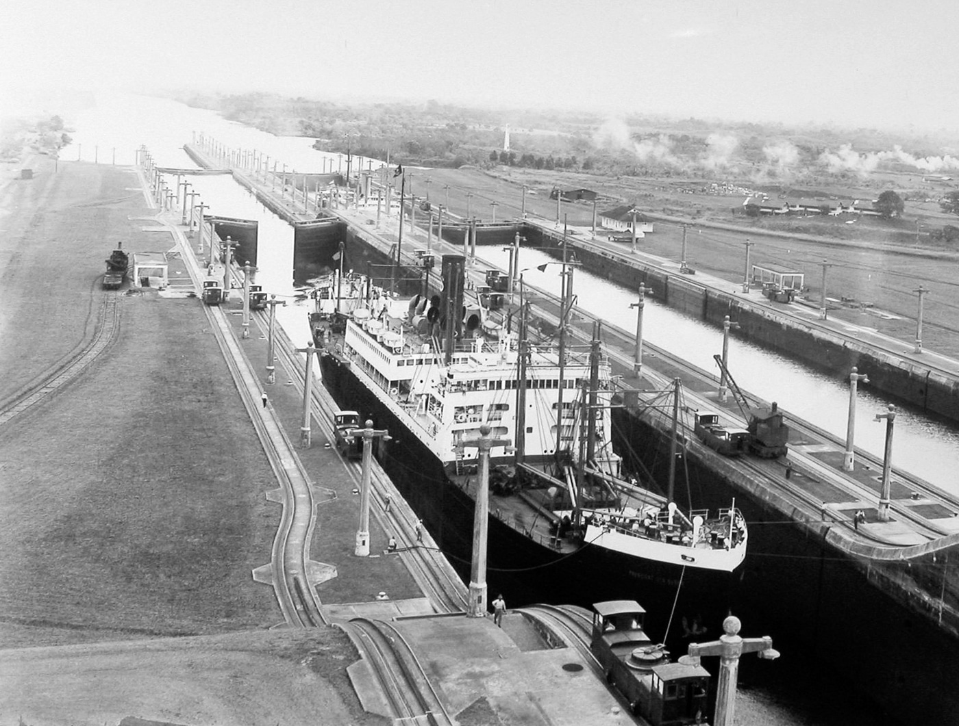 A historical photo of the Gatun Locks in the Panama Canal, the proposed target for Japan’s planned 1945 submarine-launched air raid. The image shows the lock chambers, control towers, and water channels connecting the Atlantic side of the canal. Japanese planners believed that destroying the Gatun Locks would delay the transfer of Allied ships, troops, and materials from the European Theater of Operations (ETO) to the Pacific Theater of Operations (PTO) after Germany’s surrender. The attack was to be carried out by Aichi M6A Seiran bombers launched from I-400 class submarine aircraft carriers. This photograph captures the scale and engineering precision of the locks and underscores their importance to Allied strategy.