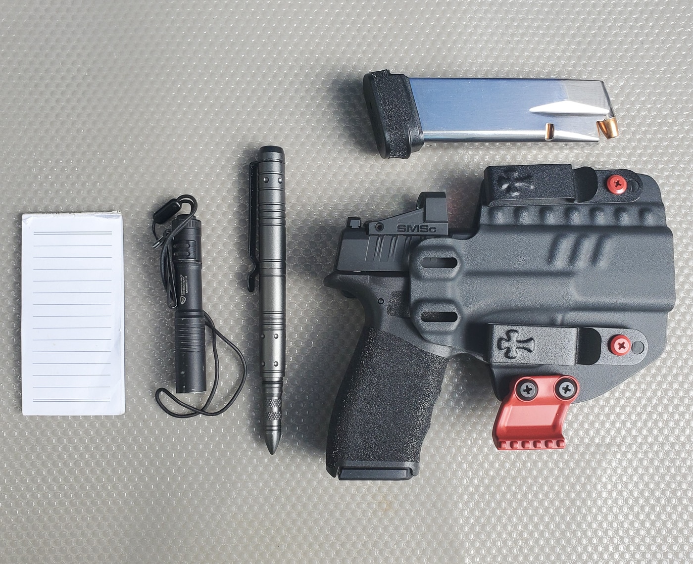EDC equipment and self-protection tools displayed as an introduction to personal safety gear and everyday carry essentials. Featured items include defensive tools for threat response, illumination devices for dark environments, cutting implements for utility tasks, and first aid components for treating injuries in emergency situations. The spread also shows communication devices critical for calling for help, along with supplementary preparedness items that round out a complete get-home bag or vehicle emergency kit. This everyday carry setup reflects a balanced approach to personal security that emphasizes practical self-defense readiness without unnecessary tactical gear, suitable for urban or rural environments and adaptable to various climate conditions.