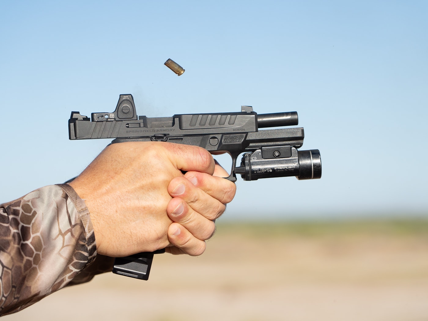 Springfield Echelon pistol recoil control demonstration showing proper grip technique during shooting drill execution on firearms training range. Top shooting drills emphasize recoil management skills through proper hand placement, grip pressure, and stance fundamentals for accurate rapid-fire shooting. Best pistol shooting exercises work recoil control technique to maintain muzzle alignment and enable faster follow-up shot capability during timed drills. Proper grip fundamentals for shooting drills include high hand position, support hand pressure, and consistent technique that manages pistol recoil effectively. Dynamic handgun training drills test recoil management skills under realistic conditions including movement, elevated heart rate, and multiple target transitions. Professional shooting drill practice incorporates recoil control fundamentals to build speed without sacrificing accuracy during rapid-fire exercises. Echelon pistol grip technique demonstrates proper hand placement for managing 9mm recoil during demanding shooting drill sequences. Effective recoil management training through structured shooting drills develops muscle memory for consistent grip application and muzzle control throughout firing strings.