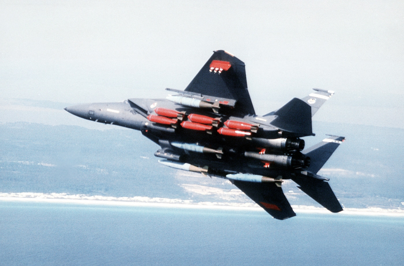 McDonnell Douglas F-15E Strike Eagle tactical fighter bomber configured for ground attack mission with external weapons mounted on wing pylons and fuselage hardpoints. The twin-engine multirole combat aircraft features conformal fuel tanks providing extended range for deep strike operations against enemy ground positions. Strike Eagle weapons delivery capabilities include precision-guided munitions, conventional bombs, and specialized ordnance for different target types. The F-15E platform employs LANTIRN targeting pods with terrain-following radar and infrared sensors for low-altitude weapons delivery in any weather conditions. United States Air Force Strike Eagles have conducted ground attack missions during Operation Desert Storm, Operation Iraqi Freedom, and combat operations in Syria and Libya. The two-seat tactical fighter features Weapons System Officer coordinating targeting and weapons employment using AN/APG-70 radar and multi-purpose displays. F-15E airframe design incorporates robust wing structure supporting heavy ordnance loads while maintaining air-to-air combat capability for self-defense during strike missions.