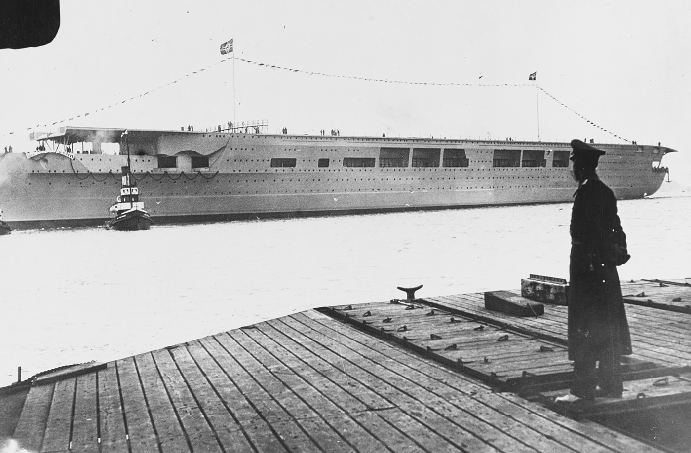 German aircraft carrier Graf Zeppelin photographed December 8 1938 launch Deutsche Werke shipyard Kiel Germany showing casemate mountings 5.9-inch guns 15cm secondary armament forward superstructure. Hitler's carrier Graf Zeppelin newly launched Kriegsmarine flattop displacement 33550 tons length 262 meters Helene von Zeppelin christening ceremony. Nazi warship Graf Zeppelin-class aircraft carrier distinctive gun placements casemate type mountings twin 5.9-inch guns forward island superstructure. Third Reich carrier construction Deutsche Werke Kiel December 1938 Graf Zeppelin launch ceremony Kriegsmarine naval aviation flattop. German carrier armament debates offensive firepower versus aircraft capabilities casemate mountings 15cm guns Graf Zeppelin superstructure design Hitler's carrier program.