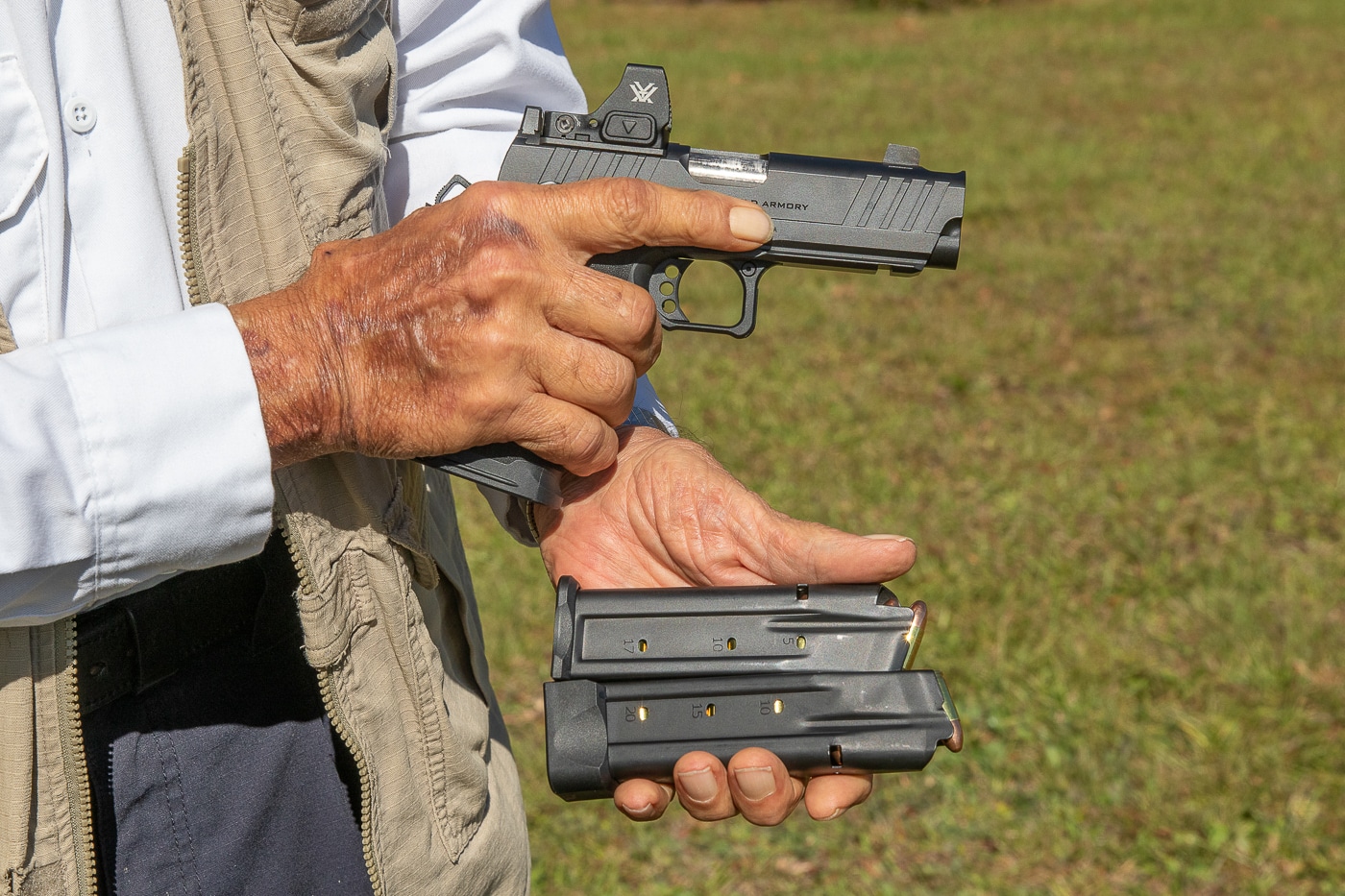 Massad Ayoob holding Springfield Armory Prodigy Comp with two spare magazines