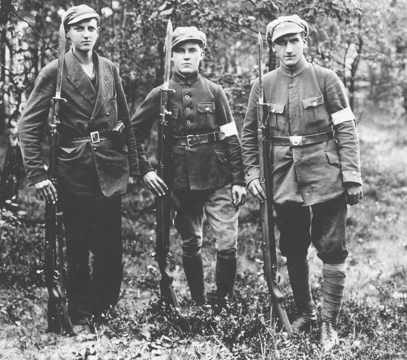 Historical photograph from 1919 showing Polish insurgent fighters armed with German Gewehr 98 bolt-action rifles during combat operations against Bolshevik invasion forces illustrating widespread use of surplus German military weapons throughout Eastern Europe following World War I armistice. The Polish fighters hold Gew 98 rifles with characteristic 29-inch barrels, straight bolt handles, and full-length wooden stocks that became essential weapons for Polish irregular forces, resistance groups, and military units fighting Soviet expansion during Polish-Soviet War of 1919-1921. These Polish combatants equipped with 7.92x57mm Mauser chambered Gewehr 98 rifles benefited from same reliable controlled-feed Mauser action, five-round magazine capacity, and robust construction that served millions of German soldiers during 1914-1918 Great War trenches. The image demonstrates how G98 rifles transitioned from Imperial German Army service to arming Polish independence fighters defending their nation against communist forces when millions of surplus German bolt-action rifles flooded Eastern European markets after World War I ended.
ALT TEXT 2:
Polish resistance fighters photographed in 1919 carrying Mauser Gewehr 98 bolt-action rifles during anti-Bolshevik operations showing how German military surplus weapons equipped Eastern European forces fighting Soviet communist expansion after World War I. The Polish insurgents armed with Gew 98 rifles demonstrate widespread availability of reliable 7.92x57mm chambered German bolt-action rifles that Polish fighters used during crucial battles of Polish-Soviet War when Poland struggled to maintain independence against Bolshevik invasion forces. These Polish combatants with their Gewehr 98 rifles featuring controlled-feed actions, straight bolt handles, and 49-inch overall length represent typical irregular units that relied on captured or surplus German weapons during 1919-1921 conflict. The photograph illustrates how over nine million G98 rifles produced for Imperial German Army from 1898-1918 found new service arming various European forces during interwar period when Polish fighters needed dependable bolt-action rifles for resisting Soviet territorial ambitions in Eastern Europe.
ALT TEXT 3:
Group of Polish insurgent fighters armed with German Gewehr 98 bolt-action rifles during 1919 combat operations against Bolshevik forces demonstrating critical role of surplus German military weapons in Polish defense during Polish-Soviet War following World War I. The Polish resistance fighters carry Gew 98 rifles with visible long barrels and Mauser bolt actions that proved essential armament when Poland faced Soviet invasion and Polish irregular forces, volunteer units, and organized military needed reliable firearms chambered in widely available 7.92x57mm Mauser ammunition. These Polish combatants equipped with Gewehr 98 rifles benefited from same tough reliable controlled-feed design with dual locking lugs, positive extraction, and robust steel construction that served German soldiers like Adolf Hitler during Great War trenches at Ypres, Somme, and Fromelles from 1914-1918. The 1919 photograph shows how German G98 bolt-action rifles transitioned from trench warfare service to new conflicts across Eastern Europe when Polish fighters defending their independence against Bolshevik expansion relied on proven Mauser 98 action rifles that remained effective military weapons during interwar period leading to World War II.

Ready for the next [PHOTO DESCRIPTION].RetryClaude can make mistakes. Please double-check responses.