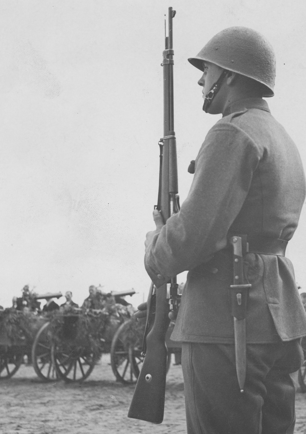 Polish rifleman from 1st Naval Rifle Battalion photographed circa 1937 in Wejherowo holding Mauser wz. 98 bolt-action rifle with attached Polish wz. 28 bayonet demonstrating continued military use of Gewehr 98 derivative designs in interwar Poland. The Mauser wz. 98 rifle represents Polish military variant based directly on German Gew 98 action using same 7.92x57mm Mauser cartridge and controlled-feed bolt system that made the original Gewehr 98 successful during World War I. This Polish naval infantry soldier displays the full-length military rifle with wooden stock, barrel bands, and characteristic straight bolt handle inherited from German G98 design. The wz. 28 bayonet mounted on the rifle demonstrates Polish domestic production of both rifles and edged weapons for their armed forces during 1930s period leading up to World War II when Poland would face German invasion.
