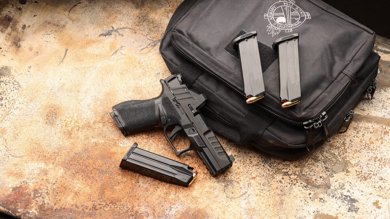 Springfield Armory Echelon Gear Pac bundle showing modular striker-fired pistol with factory-installed Viridian RFX11 green dot reflex sight featuring matching slide serrations. The Echelon Gear Pac configuration includes four pistol magazines, protective carrying case, and pre-mounted optic delivering immediate shooting capability without post-purchase installation requirements. Springfield Echelon pistol with Gear Pac accessories represents complete defensive handgun package combining modular platform versatility with complementary goods worth up to $375. Factory-installed green dot sight on Echelon features serrations and grooves matching pistol slide cuts for integrated appearance and improved grasping surface during slide manipulation. Optic-ready Echelon pistol comes with RFX11 reflex sight offering 3 MOA green dot reticle, Instant-On technology with ambient light sensor, and 30,000-hour battery runtime from CR2032 power source. Four-magazine complement supports concealed carry applications, home defense scenarios, and training sessions requiring multiple pre-loaded magazines for reload practice. Echelon Gear Pac bundle includes slide cover plate allowing iron sight configuration if shooter prefers traditional sighting system or co-witness setup through mounted optic. Springfield modular pistol platform with complete accessory package eliminates need to source complementary shooting gear separately.