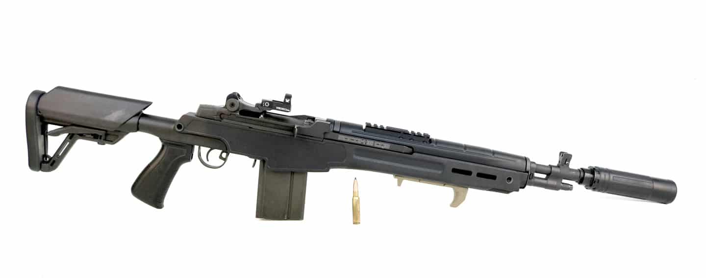 Springfield Armory SOCOM 16 CQB rifle equipped with Dead Air Sandman X centerfire rifle suppressor as tested in this comprehensive sound suppressor review evaluating performance on 7.62x51mm NATO platforms. The modernized M14 variant features abbreviated 16-inch barrel, high-tech Archangel polymer collapsible stock, and piston-driven operating system that runs reliably and clean when paired with the Sandman X suppressor can. The .308 Winchester chambering produces significantly more muzzle blast than 5.56mm rifles, making effective sound suppression critical for shooter comfort and hearing protection. Dead Air's Sandman X with Haynes 282 superalloy construction handles the increased thermal load from .308 ammunition without degradation in performance or structural integrity. The SOCOM 16's factory combination flash suppressor and muzzle brake requires an inexpensive thread pitch adapter to accept standard 5/8x24 threading for .30-caliber suppressor mounts. Once compatible Dead Air KeyMo or Xeno flash suppressor mount is installed, the Sandman X attaches tool-free for quick suppressor swapping between multiple host firearms. The thoroughly modern M14 platform with its reliable gas piston system proves as dependable as advertised when suppressed, shooting factory ammunition with consistent accuracy while the Triskelion Gas Management System channels combustion gases forward.