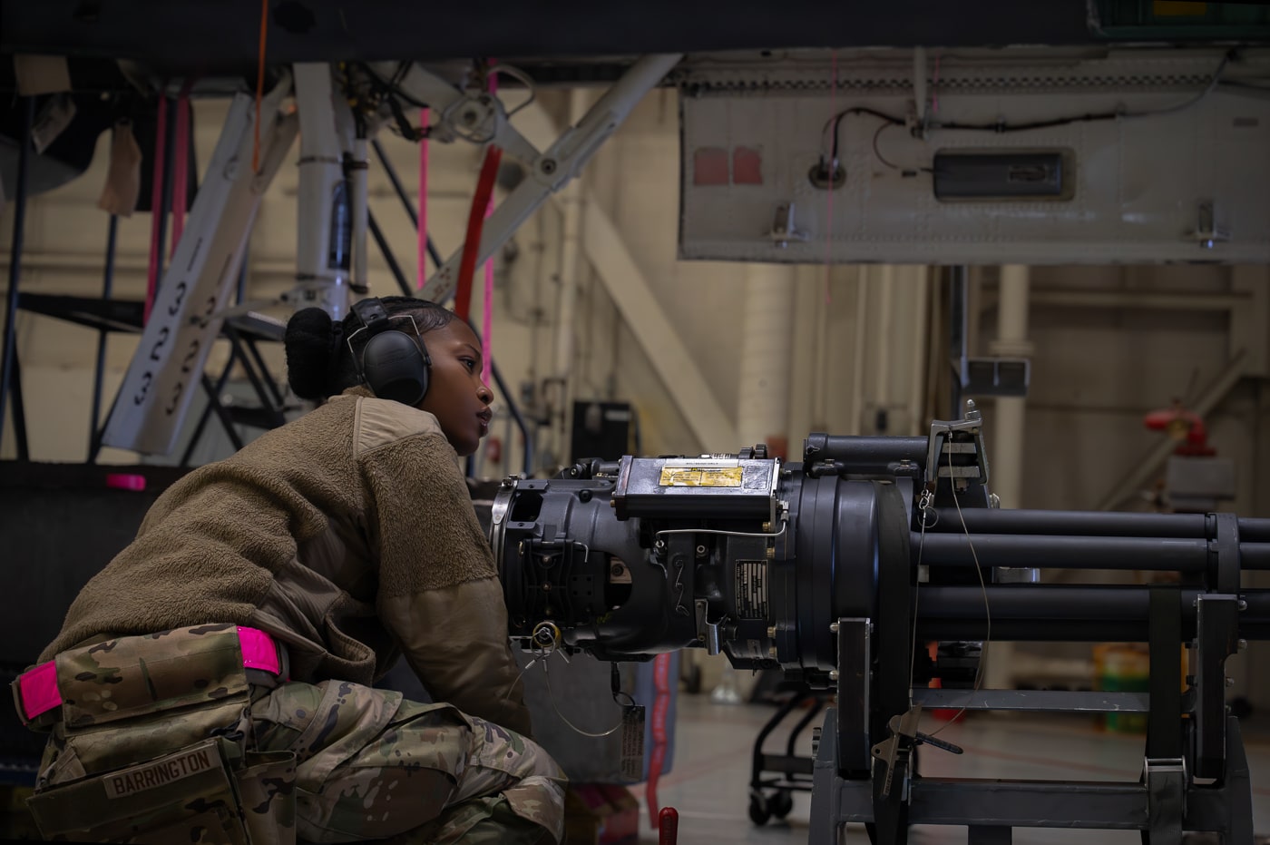 United States Air Force armament systems specialist conducting maintenance inspection on M61A1 Vulcan 20mm rotary cannon removed from F-15E Strike Eagle tactical fighter. The six-barrel Gatling-style gun provides Strike Eagle with close-range air-to-air combat capability and ground strafing firepower carrying up to 500 rounds of 20mm ammunition. Air Force weapons technicians perform regular inspections of cannon barrel assemblies, rotating mechanism, ammunition feed systems, and firing controls ensuring M61A1 remains combat ready. The F-15E platform employs M61A1 cannon mounted internally in right wing root with ammunition storage in fuselage compartment. Strike Eagle armament specialists train at technical schools learning weapons system maintenance, gun system troubleshooting, and ammunition handling procedures supporting tactical fighter operations. The M61A1 Vulcan cannon fires high-explosive incendiary rounds at rates up to 6,000 rounds per minute for engaging enemy aircraft and ground targets. United States Air Force maintains strict safety protocols during armament system maintenance with trained technicians conducting inspections between combat sorties and training missions.