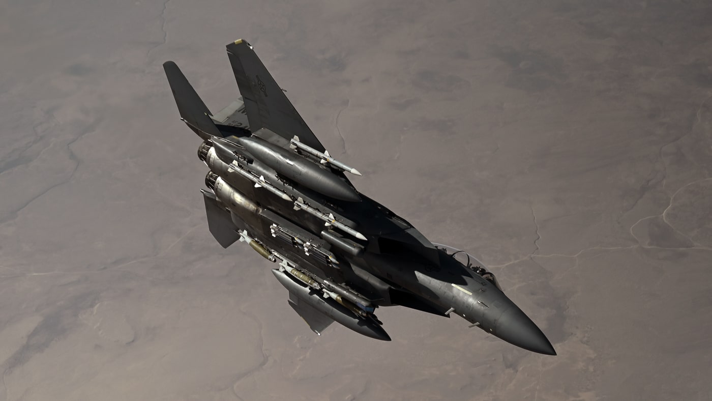 United States Air Force F-15E Strike Eagle tactical fighter conducting combat air patrol mission over U.S. Central Command area of responsibility in Middle East. The twin-engine multirole combat aircraft maintains air superiority presence protecting coalition forces and enforcing airspace control over Iraq, Syria, and surrounding regions. F-15E Strike Eagles deploy from Al Udeid Air Base Qatar, Al Dhafra Air Base United Arab Emirates, and other forward operating locations supporting Operation Inherent Resolve and counter-terrorism missions. The all-weather tactical fighter features conformal fuel tanks providing extended loiter time for combat air patrol operations across vast desert regions. Strike Eagles carry mixed weapons loadout including AIM-120 AMRAAM air-to-air missiles, AIM-9 Sidewinder missiles, and precision-guided bombs for responding to both aerial threats and ground targets. United States Air Force CENTCOM operations involve F-15E aircraft conducting defensive counter-air missions, close air support for ground forces, and strikes against ISIS positions and Iranian-backed militant groups. The dual-role fighter employs AN/APG-82 AESA radar detecting both air and ground targets at extended ranges supporting combat operations throughout Middle East theater.