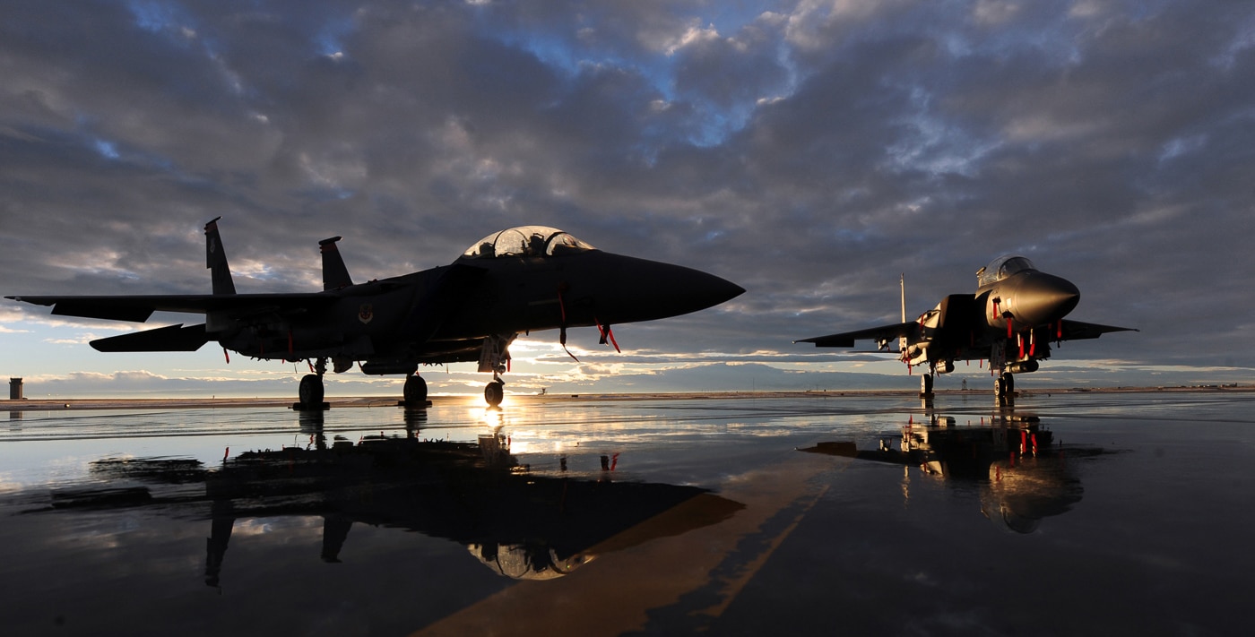 Multiple McDonnell Douglas F-15E Strike Eagle tactical fighters positioned on flight line at Mountain Home Air Force Base Idaho showing dual-role combat aircraft assigned to 366th Fighter Wing. The twin-engine multirole fighters display conformal fuel tanks, external weapons mounting points, and distinctive twin vertical stabilizers characteristic of Eagle family airframes. Mountain Home AFB serves as operational base for F-15E squadrons conducting training missions over Idaho ranges and deploying Strike Eagles for combat operations worldwide. The flight line operations include aircraft maintenance, pre-flight inspections, weapons loading, and mission preparation for Strike Eagle crews. United States Air Force 366th Fighter Wing operates F-15E aircraft alongside F-15C air superiority fighters providing comprehensive air combat capabilities. Mountain Home based Strike Eagles participate in Red Flag exercises at Nellis AFB Nevada, Green Flag training at Mountain Home ranges, and deployments supporting CENTCOM operations in Middle East. The tactical fighter wing maintains combat readiness through realistic training scenarios preparing F-15E crews for air-to-air engagements, precision strike missions, and close air support operations.