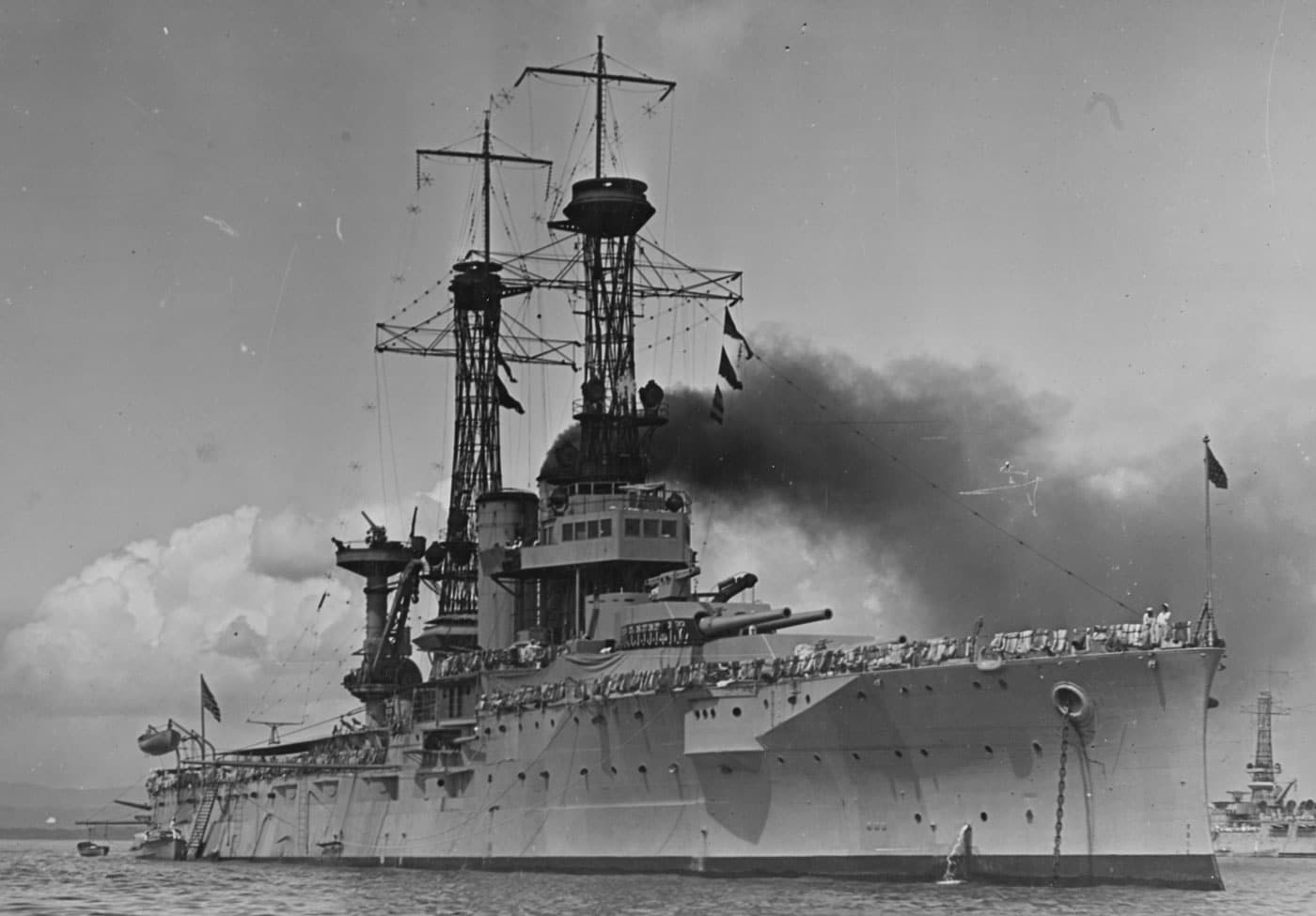 USS Florida American dreadnought battleship anchored and preparing to get underway, representing one of two Florida-class vessels that were slightly larger than previous United States dreadnoughts and featured modern steam turbine engines for improved propulsion. The Florida-class United States battleships consisted of USS Florida BB-30 and USS Utah BB-31, both equipped with ten 12-inch guns mounted in five turrets matching the armament layout of the Delaware-class dreadnoughts. These American dreadnought battleships were built with steam turbine engines rather than reciprocating engines, representing advancing propulsion technology that would become standard on all subsequent United States Navy battleships including super-dreadnoughts and fast battleships. Both Florida-class vessels served during World War I operations, contributing to American naval power during the Great War alongside other United States battleships in the expanding dreadnought fleet. The USS Florida BB-30 would eventually be decommissioned in 1931 during peacetime naval reductions, but USS Utah BB-31 holds the unfortunate distinction of being the oldest battleship in the United States Navy during World War II. On December 7, 1941, USS Utah was tied up on Battleship Row at Pearl Harbor when Japanese forces launched their surprise attack, and the aging battleship was hit by torpedoes, rolled over, and sank with 58 men dying aboard. The photograph captures USS Florida at anchor preparing for operations, showing the characteristic dreadnought profile with uniform heavy gun turrets, cage masts, and substantial superstructure typical of American battleship architecture during the early dreadnought era. As evolutionary improvements over the Delaware-class, the Florida-class dreadnought battleships demonstrated the continuing refinement of American battleship design as the United States Navy progressed toward super-dreadnoughts, standard-type battleships, and eventually the mighty fast battleships of World War II.