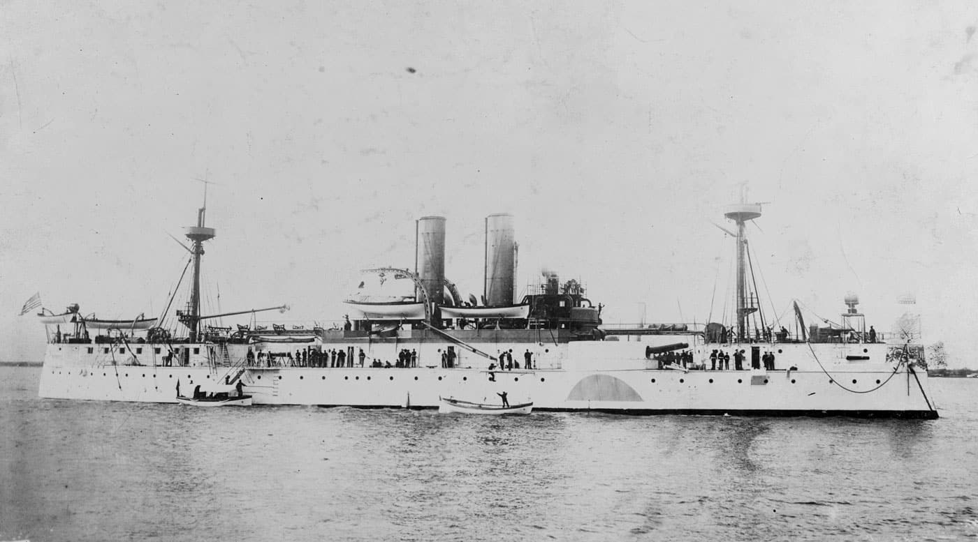 Historic photograph of USS Maine circa 1898, showing the American warship that would become one of the most famous vessels in United States naval history due to her mysterious destruction in Havana Harbor. This pre-dreadnought era warship represented early American naval construction and the United States Navy's growing capabilities before the all-big-gun battleship revolution transformed naval warfare. The USS Maine, sometimes classified as a second-class battleship or armored cruiser rather than a true first-line battleship, served alongside contemporary vessels like USS Texas and the Indiana-class battleships during America's naval expansion in the 1890s. Her mixed-caliber armament and modest displacement were typical of pre-dreadnought warships built before the HMS Dreadnought revolutionized battleship design in 1906. The vessel's presence in Cuban waters during the Spanish-American War era demonstrates how United States battleships and cruisers projected American power in the Caribbean and Latin America. When the Maine exploded and sank in Havana Harbor, her loss became the rallying cry that propelled America into war with Spain, where U.S. Navy battleships including the Indiana-class vessels would prove their worth in combat. This image captures the USS Maine during her operational service, showing the design characteristics of late 19th century American naval architecture before dreadnought-type battleships dominated the seas. The photograph represents a crucial moment in American battleship history when the United States Navy was transitioning from a coastal defense force to a fleet capable of projecting power across oceans and protecting American interests worldwide.