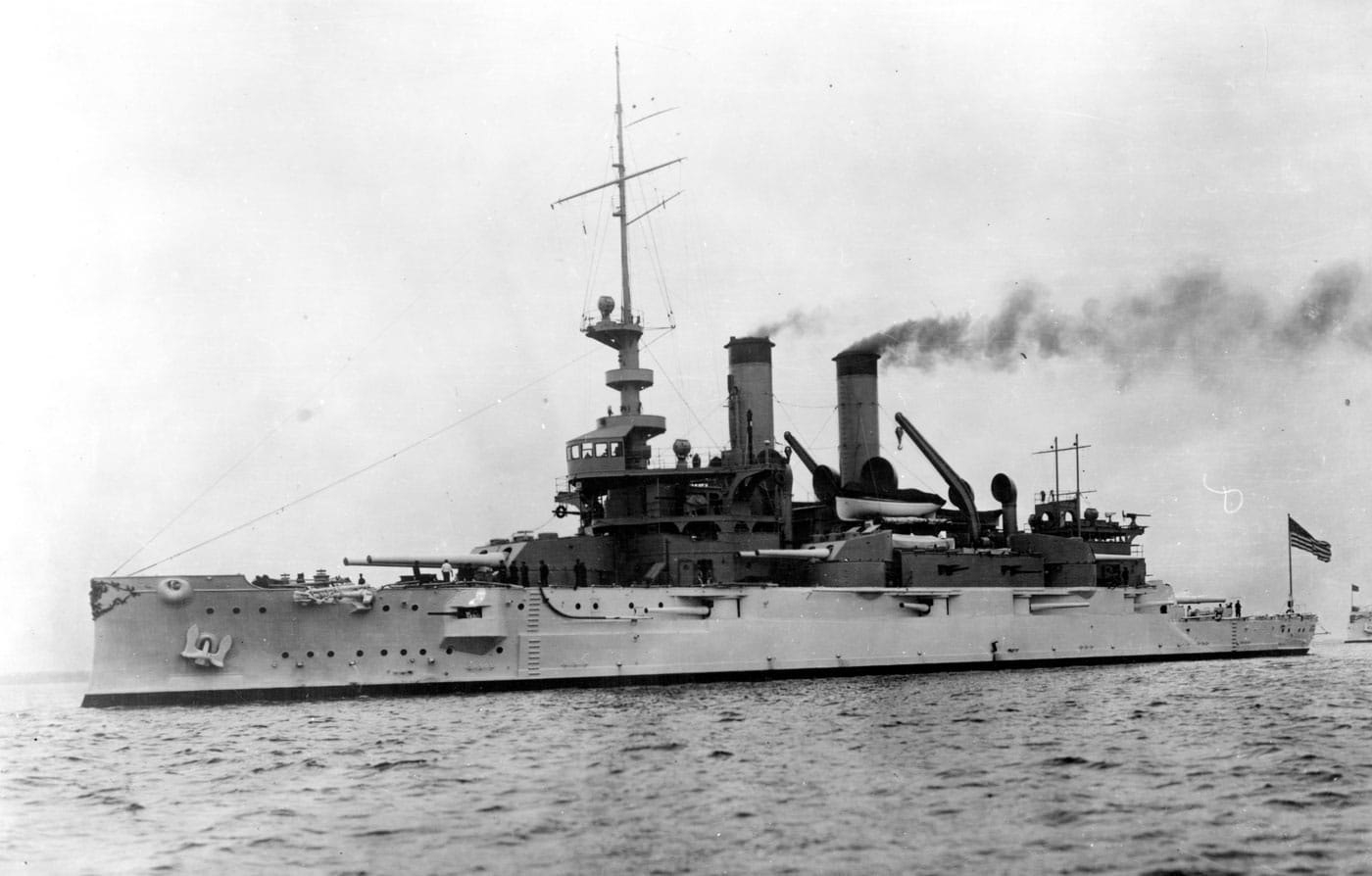 USS Mississippi battleship underway and cleared for action in 1908, representing one of two Mississippi-class pre-dreadnought battleships that were the last old-style American battleships commissioned by the United States Navy. The Mississippi-class consisted of just USS Mississippi BB-23 and USS Idaho BB-24, vessels that many naval historians consider the finest pre-dreadnought battleships built by the United States to that point, yet they were completely obsolete when they commissioned in 1908 due to the dreadnought revolution. The photograph shows USS Mississippi in wartime configuration cleared for action, demonstrating the combat readiness of these American battleships despite their outdated mixed-caliber design that was instantly obsolete after HMS Dreadnought revolutionized naval warfare in 1906. After serving just six years in the United States Navy, both Mississippi-class battleships were sold to Greece in 1914, where they were renamed Kilkis and Lemnos and continued distinguished service under the Greek flag for decades. As Greek battleships, the former American vessels served in the Allied intervention during the Russian Civil War and participated in combat operations during the Greco-Turkish War, demonstrating the continued viability of well-built pre-dreadnought battleships in regional conflicts. The ships again saw action in 1940 when Italy invaded Greece, with Greek forces successfully pushing Italian forces back, but in 1941 the German Wehrmacht invaded and both battleships were attacked by Junkers Ju 87 dive bombers at Salamis Naval Base. The Greek battleship Kilkis, formerly USS Mississippi BB-23, was sunk during the German air attacks while Lemnos, formerly USS Idaho BB-24, was intentionally beached to prevent her sinking. This image captures USS Mississippi during her brief United States Navy service when these pre-dreadnought battleships represented the pinnacle of American mixed-caliber warship construction, even though advancing technology had already made them obsolete before they could contribute to U.S. fleet operations.