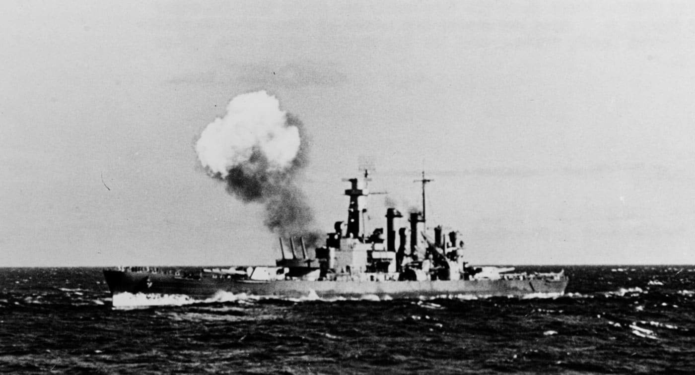USS North Carolina BB-55 American fast battleship firing main guns during gunnery training in 1941, representing one of two North Carolina-class vessels that were the first fast battleships built by the United States Navy and marked a revolutionary departure from standard-type battleship designs. The North Carolina-class United States fast battleships consisted of USS North Carolina BB-55 and USS Washington BB-56, both fitted with three turrets each holding three 16-inch guns for a total of nine heavy guns and capable of achieving at least 28 knots maximum speed. Unlike older standard-type battleships constrained to approximately 21 knots, these fast battleships could keep up with aircraft carriers, something that would prove critically important during World War II Pacific operations where carrier task forces became the primary striking arm. The North Carolina-class fast battleships were constrained by the Second London Naval Treaty of 1936, but with Japan's refusal to sign the agreement, the United States Navy was able to arm these ships with 16-inch guns rather than smaller caliber weapons. Both North Carolina-class fast battleships were brand new and still conducting workup training on the East Coast of the United States during the Pearl Harbor attack on December 7, 1941, sparing them from the devastation that befell the Pacific Fleet. Both ships were extremely busy during World War II with USS North Carolina BB-55 awarded 15 battle stars while USS Washington BB-56 earned 13 battle stars through extensive combat operations in both Atlantic and Pacific theaters. Unfortunately, USS Washington was sold for scrap in 1961, but USS North Carolina BB-55 serves as a museum ship today and can be visited year-round in Wilmington, North Carolina, preserving this revolutionary fast battleship design for future generations. The dramatic photograph shows USS North Carolina firing her main battery during 1941 training, demonstrating the firepower of American fast battleships that would dominate naval warfare alongside the South Dakota-class and Iowa-class vessels. As the first fast battleships, the North Carolina-class represented the United States Navy's successful transition from treaty-constrained standard-type battleships to modern high-speed capital ships capable of operating with fast carrier task forces.