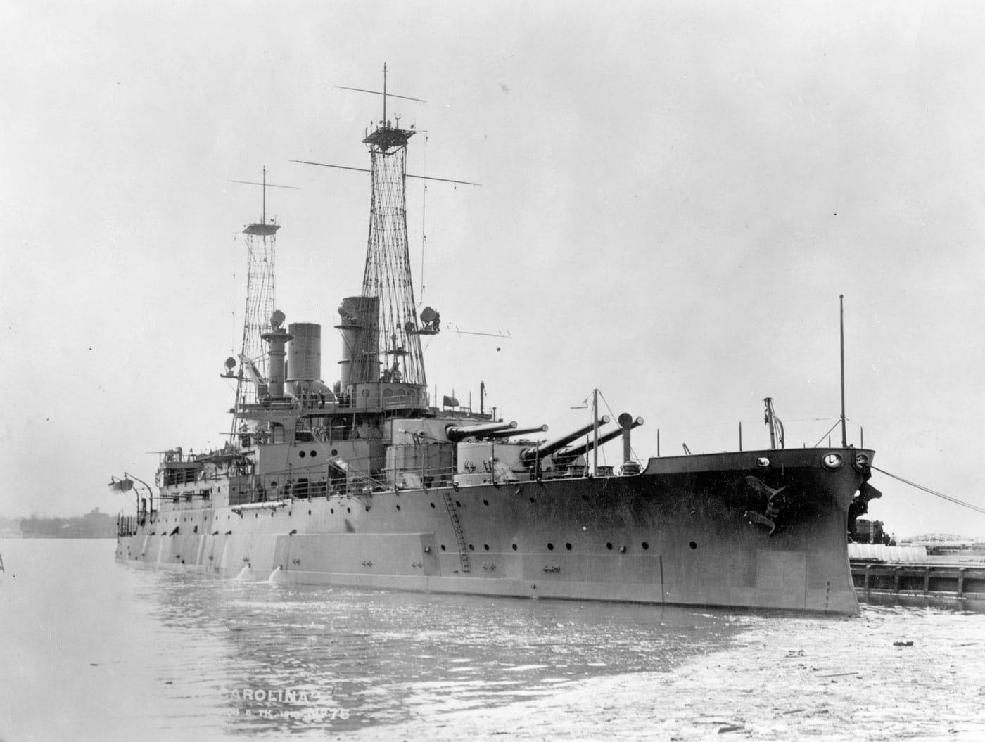 USS South Carolina BB-26 battleship photographed during service, representing one of two South Carolina-class vessels that were the first dreadnoughts built by the United States Navy and marked America's entry into the all-big-gun battleship era. The South Carolina-class American dreadnoughts consisted of USS South Carolina BB-26 and USS Michigan BB-27, both fitted with eight 12-inch guns that doubled the heavy firepower of prior United States battleships that featured mixed-caliber armament. These first American dreadnoughts represented a revolutionary new direction in U.S. Navy battleship design, visually resembling the most modern battleships that America would eventually field with superfiring turret arrangements and uniform heavy gun batteries. The South Carolina-class dreadnought battleships were shorter and lighter than foreign dreadnoughts built by other naval powers, but they established the all-big-gun philosophy that would define American battleship construction for decades. Despite their revolutionary armament, these American dreadnoughts were relatively slow with maximum speeds less than 19 knots, limiting their tactical flexibility compared to faster foreign battleships and later United States Navy fast battleships. Both South Carolina-class vessels were commissioned in 1910, beginning a new era of American dreadnought battleship construction that would eventually lead through super-dreadnoughts to standard-type battleships and ultimately the mighty Iowa-class fast battleships. The photograph shows USS South Carolina BB-26 displaying the characteristic dreadnought profile with uniform heavy gun turrets, substantial superstructure, and cage masts that would become iconic features of American battleships. Both South Carolina-class dreadnoughts were broken up in 1924 due to the notorious Washington Naval Treaty that forced the United States Navy to eliminate older capital ships to comply with international limitations on battleship tonnage and numbers.