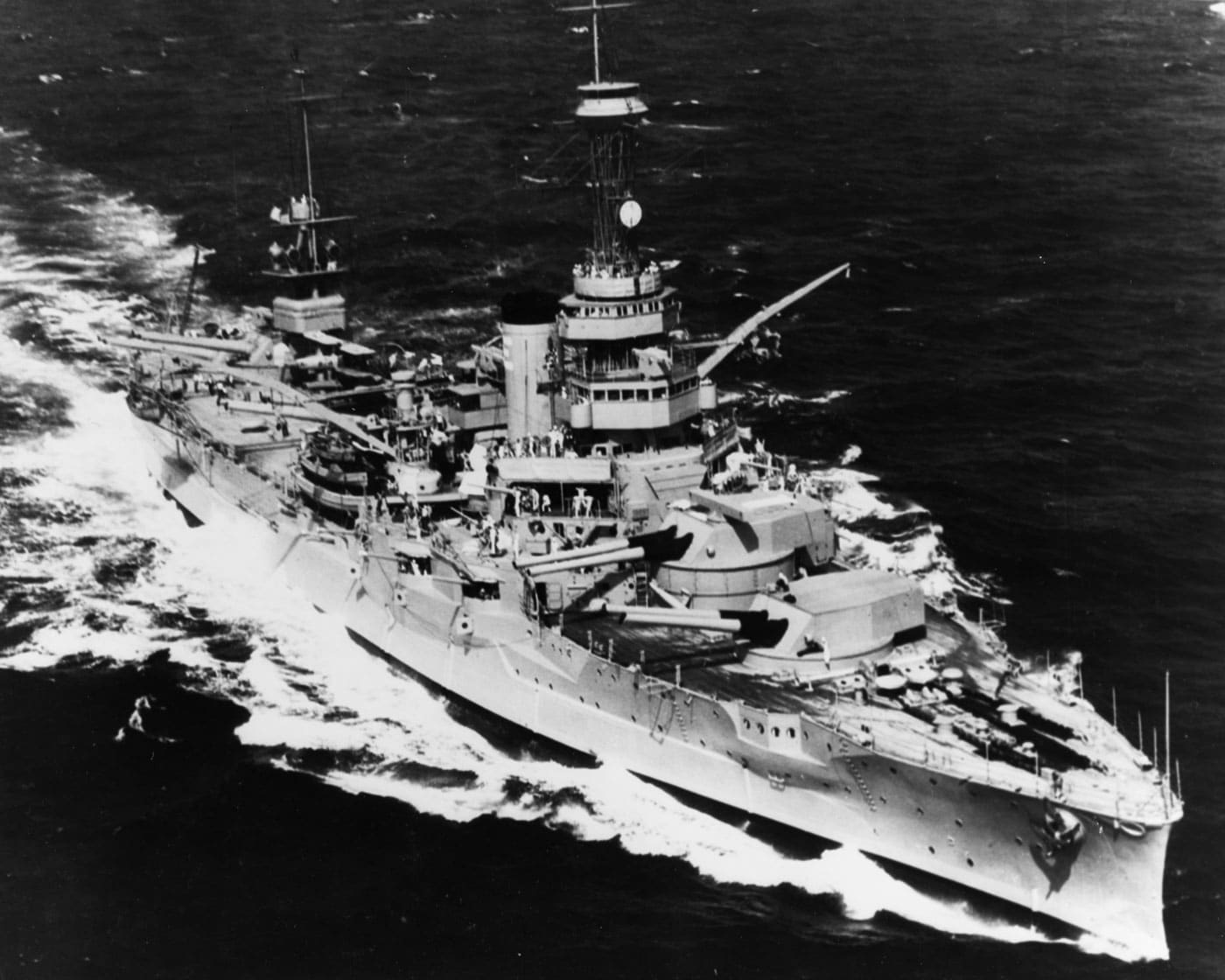 USS Wyoming BB-32 United States dreadnought battleship underway with her twelve 12-inch guns trained to starboard, representing one of two Wyoming-class vessels that featured the most heavy guns of any American dreadnought battleships to that point. The Wyoming-class American dreadnoughts consisted of USS Wyoming BB-32 and USS Arkansas BB-33, both equipped with six turrets mounting twelve 12-inch Mark 7 guns that were more powerful than the older model guns on earlier United States battleships. These dreadnought battleships added a sixth turret compared to the five-turret Florida-class and Delaware-class vessels, increasing heavy firepower by twenty percent over previous American dreadnought designs. Both Wyoming-class battleships served during World War I and evaded early destruction due to the Washington Naval Treaty, though USS Wyoming was eventually defanged by the 1930 London Naval Treaty that forced removal of her main guns. The USS Wyoming had all twelve main guns eventually replaced by 5-inch guns and served as a training ship stationed on the East Coast, becoming instrumental in developing tactics for countering Japanese kamikaze attacks and training countless sailors entering service after Pearl Harbor. USS Arkansas BB-33 was employed in Neutrality Patrols and convoy duties in the Atlantic during World War II, provided gun support during Operation Neptune at Normandy and Operation Dragoon in southern France, then steamed to the Pacific providing gun support at Iwo Jima and Okinawa. The photograph shows USS Wyoming underway with her impressive broadside battery trained to starboard, demonstrating the firepower concentration that made dreadnought battleships the dominant capital ships of the early 20th century. USS Arkansas earned four battle stars during World War II, becoming the oldest battleship to earn battle stars in the conflict, while USS Wyoming served vital training duties preparing American sailors for modern naval warfare.