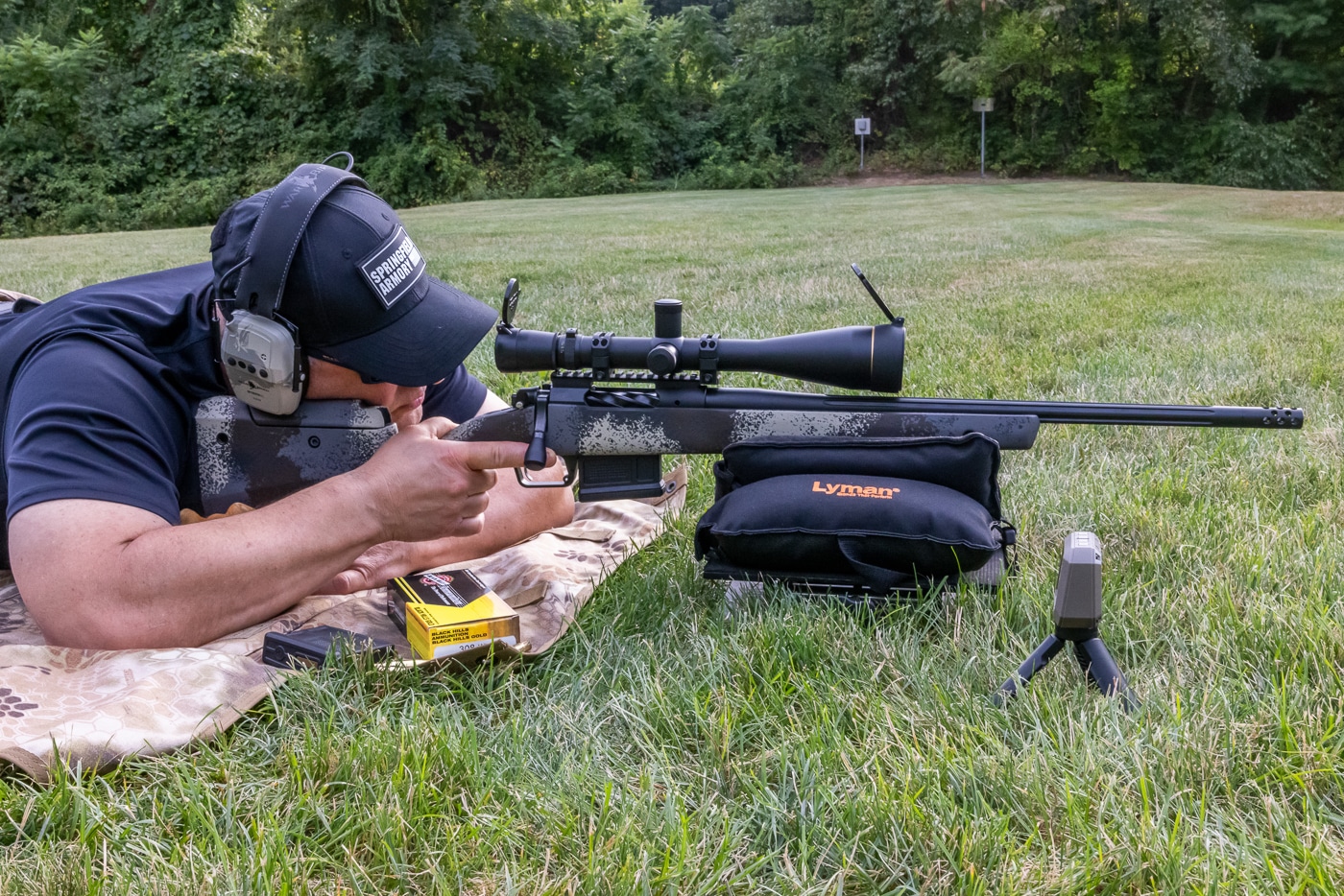 Author shooting Springfield Model 2020 Waypoint rifle in prone position during Black Hills Gold .308 168-grain ELD ammo review at 200 yards. Testing Black Hills .308 Winchester ammunition loaded with 168-gr Hornady ELD Match bullets using stable prone shooting technique. Springfield Armory Waypoint 2020 rifle paired with Black Hills Gold 308 ammo featuring 168 grain ELD projectiles. Precision rifle testing of Black Hills .308 Win cartridges with 168-gr bullets at extended range. Shooter evaluating Black Hills Ammunition Gold line .308 168 grain ELD Match loads from prone position. Springfield Model 2020 bolt-action rifle used for accuracy assessment of Black Hills .308 ammo. Range test showing Black Hills Gold .308 Winchester 168-gr ELD ammunition performance at 200 yards. Author conducting comprehensive Black Hills 308 ammo evaluation with Springfield Waypoint rifle and prone shooting position.