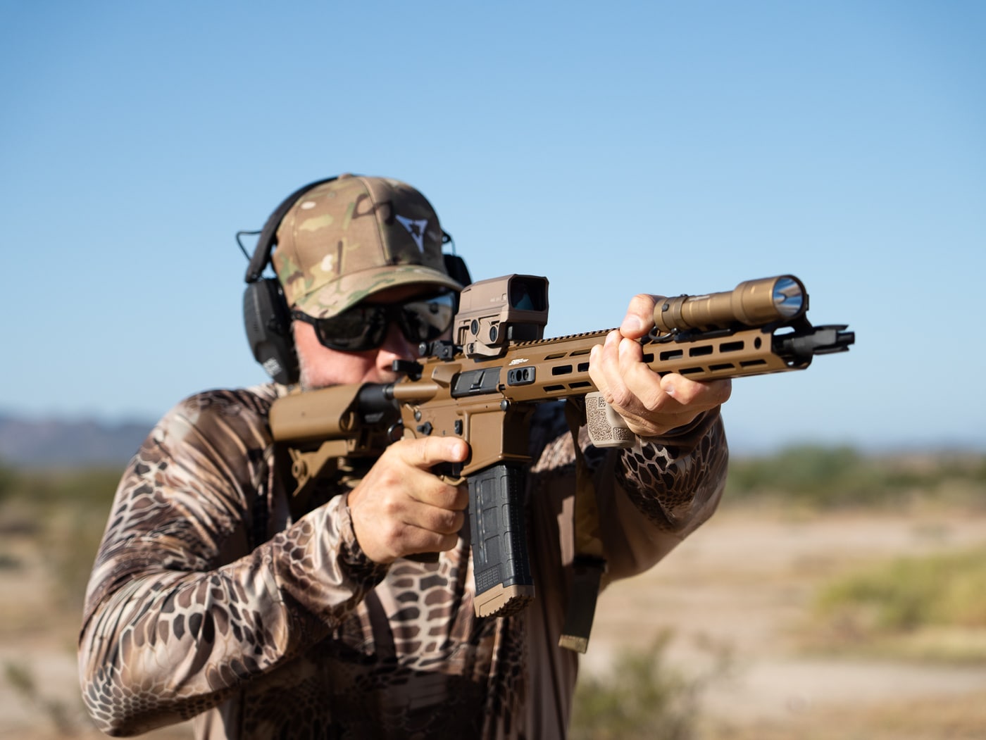 Shooter executing rifle shooting drill with AR-15 platform demonstrating proper stance and weapon control during dynamic training exercise on firearms range. Top shooting drills for rifle training include movement-based exercises that develop marksmanship fundamentals and tactical weapon handling skills. AR-15 shooting drills work essential skills including magazine changes, target engagement accuracy, and recoil management under timed conditions. Best rifle drills for firearms training combine distance variations with movement patterns to build comprehensive shooting proficiency. Rifle shooting practice exercises test multiple fundamentals simultaneously including trigger control, breathing techniques, and follow-through consistency. Dynamic shooting drills with AR-15 rifle platforms prepare shooters for realistic engagement scenarios requiring speed and precision. Professional rifle training drills incorporate competitive shooting methods merged with tactical applications for well-rounded skill development. Effective rifle shooting exercises build muscle memory through repetitive practice of weapon manipulation, sight alignment, and shot placement techniques under performance pressure.