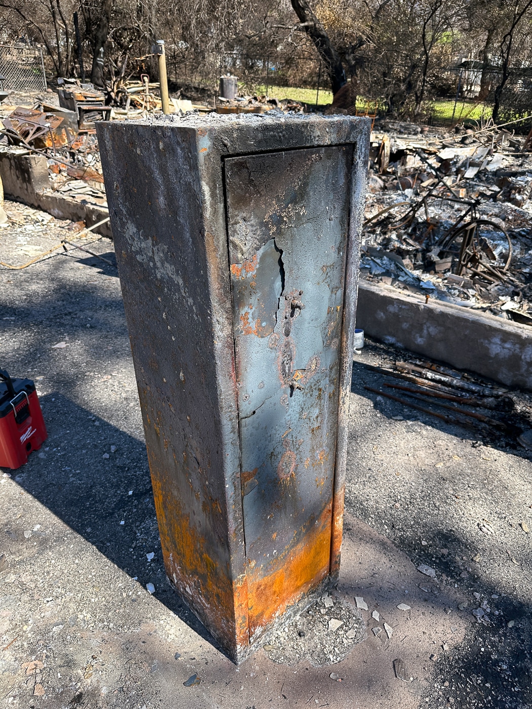 Destroyed gun safe after house fire showing why insuring your guns requires comprehensive coverage beyond relying on physical security measures alone. The fire-damaged safe demonstrates that even fire-rated gun safes have limits when protecting firearms, ammunition, optics, and accessories during intense residential fires. Gun owners must maintain adequate insurance policies for weapons stored in safes since prolonged fire exposure destroys rifles, pistols, shotguns, and related equipment regardless of safe ratings. Insurance claims for firearms destroyed inside gun safes require photographic documentation of serial numbers and inventory spreadsheets proving ownership of weapons and accessories. Proper coverage when insuring your guns accounts for total loss scenarios where safes fail to protect firearm collections, ammunition stockpiles, optics, holsters, and cleaning supplies from fire damage requiring complete replacement through insurance payouts.