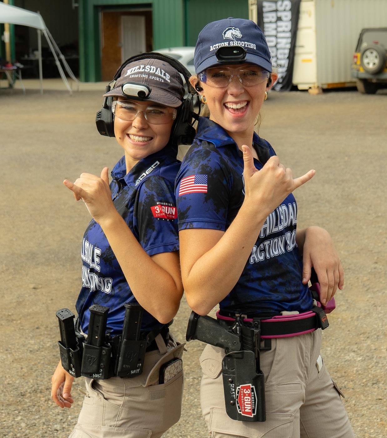 Competitors smile and enjoy themselves during the 2025 USPSA Collegiate Action Pistol Championships hosted by the Hillsdale Chargers shooting team at the John A. Halter Shooting Center in Michigan. The university action pistol athletes demonstrate that collegiate shooting competition combines serious marksmanship with fun and engaging social atmosphere at the Roger Ailes facility. Collegiate shooters from 13 university teams including Texas A&M, Naval Academy, Virginia Tech, and Michigan State show the enjoyable nature of competing at Hillsdale College championship matches. The university competitors represent athletes who appreciate the welcoming environment created by Hillsdale Chargers shooting program coaches Adam Burlew and Zechariah Steiger during the match. Action pistol shooters like these athletes experience both competitive challenge and enjoyable camaraderie at the Hillsdale competitive shooting facility where beautiful weather conditions enhanced the positive atmosphere. University marksmanship competitors demonstrate why teams intend to return next year to the Hillsdale College championship where fun and professionalism coexist throughout the event. The collegiate athletes show that USPSA action pistol competition at the Hillsdale Chargers facility provides engaging experiences beyond just stage runs and scores. These university shooting competitors represent the type of positive environment that attracts families and supporters who observe the fun alongside competitive excellence at Hillsdale College matches making it ideal for introducing younger people to shooting sports.